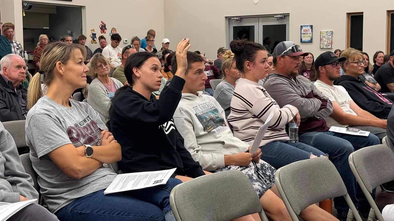 More than 100 people packed into the Midwest Recreation Center on Wednesday to begin a full-court press to save grades 6-12 of their school from the chopping block.