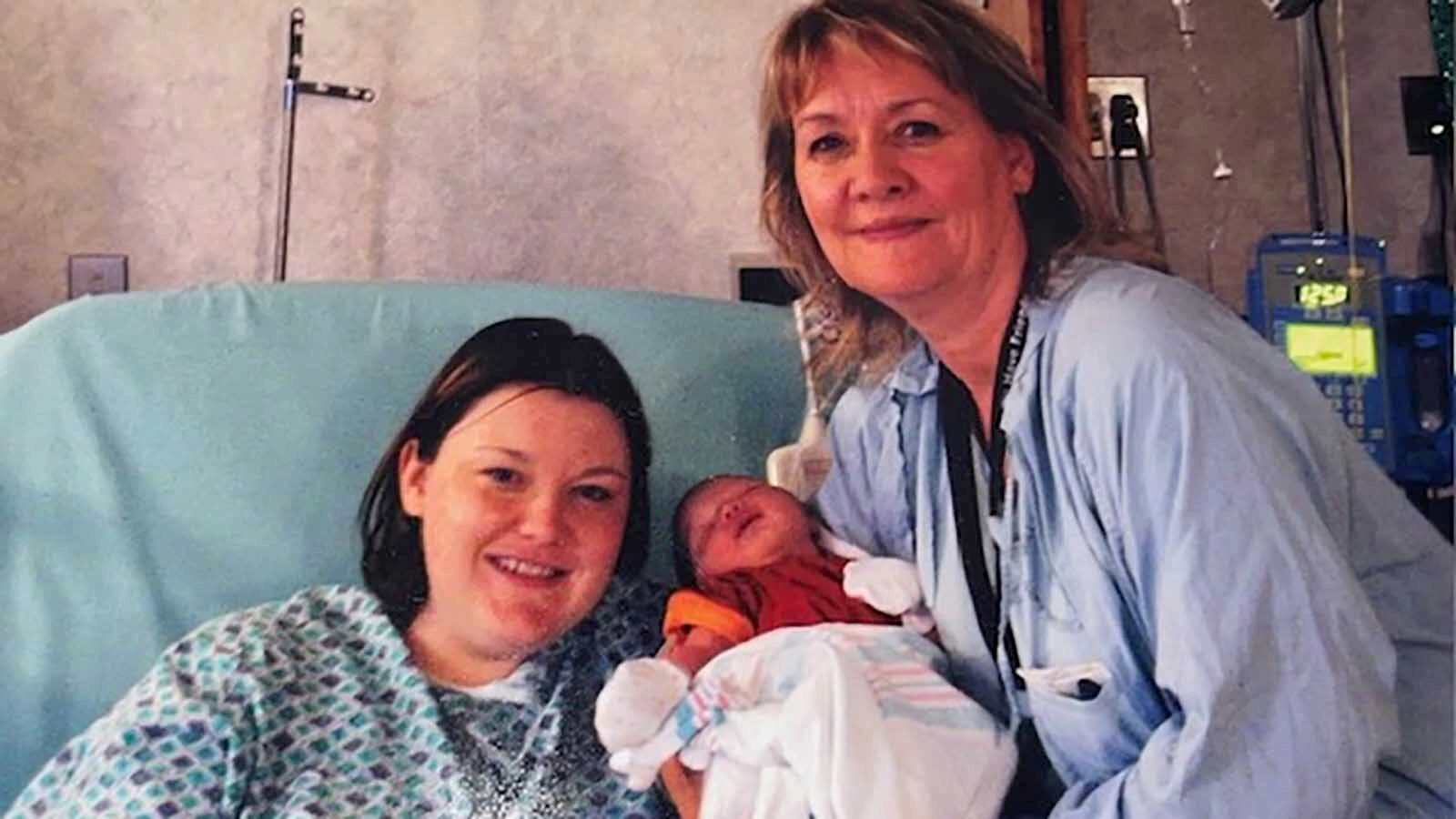 Helen LaRose posees with a happy mom and baby just after the baby was born.