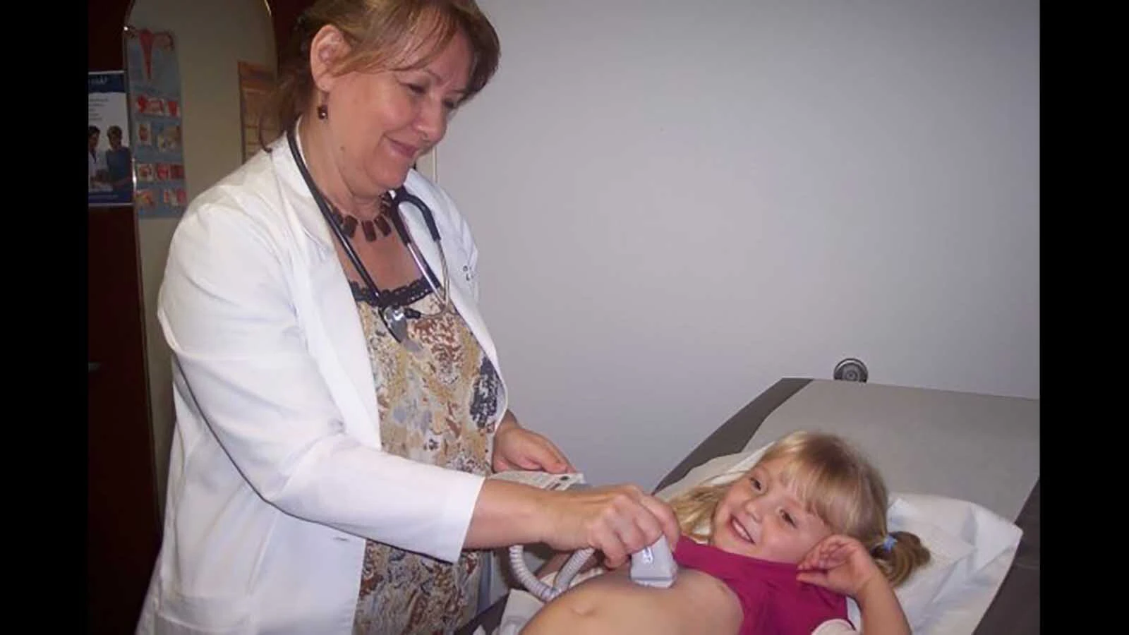 Helen LaRose in the office with the daughter of a patient who thought she was growing a baby just like mommy.