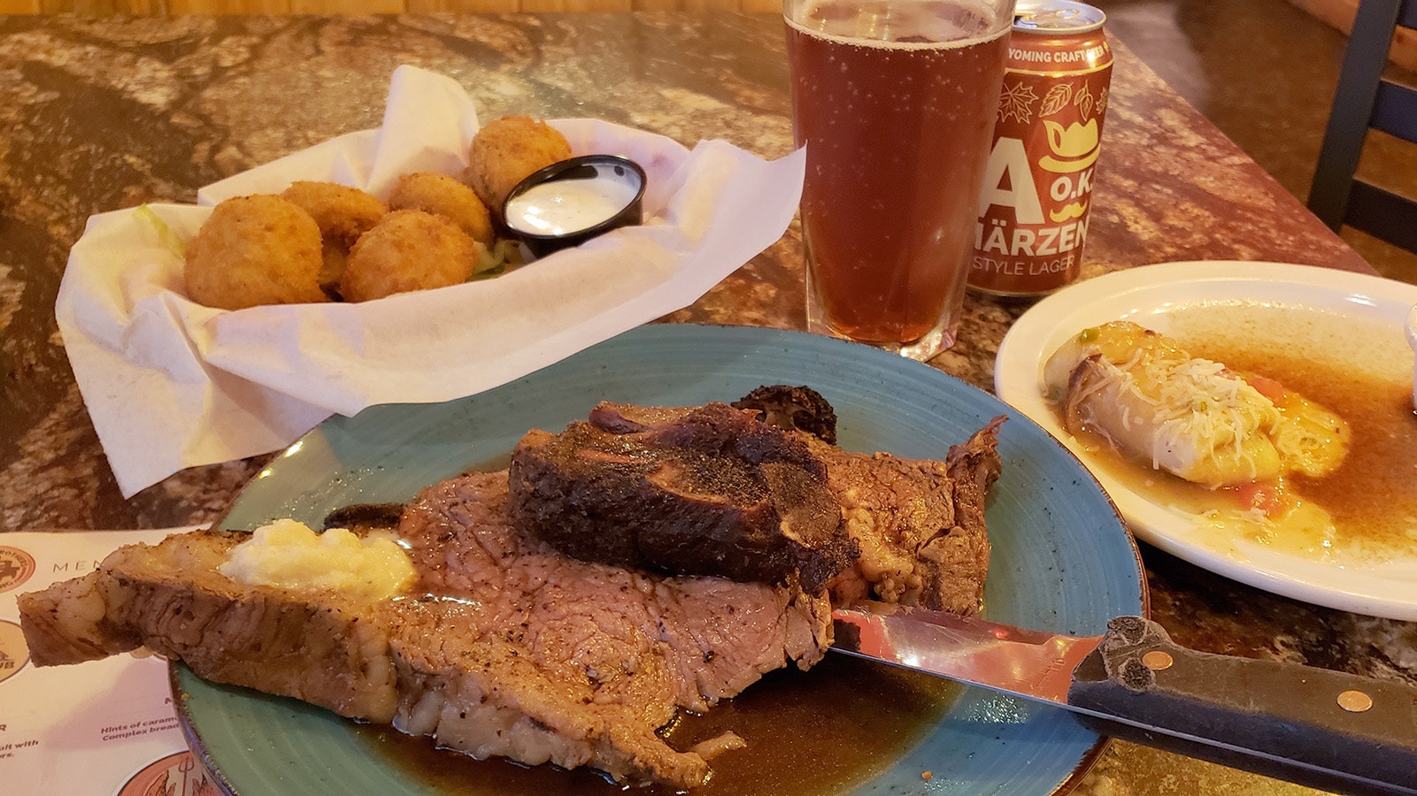 Prime rib with the signature mini chimichanga on the side, a basket of fried mushrooms and an A-OK Marzen, one of a dozen Wyoming craft beers available at Michael's Big City Steakhouse.