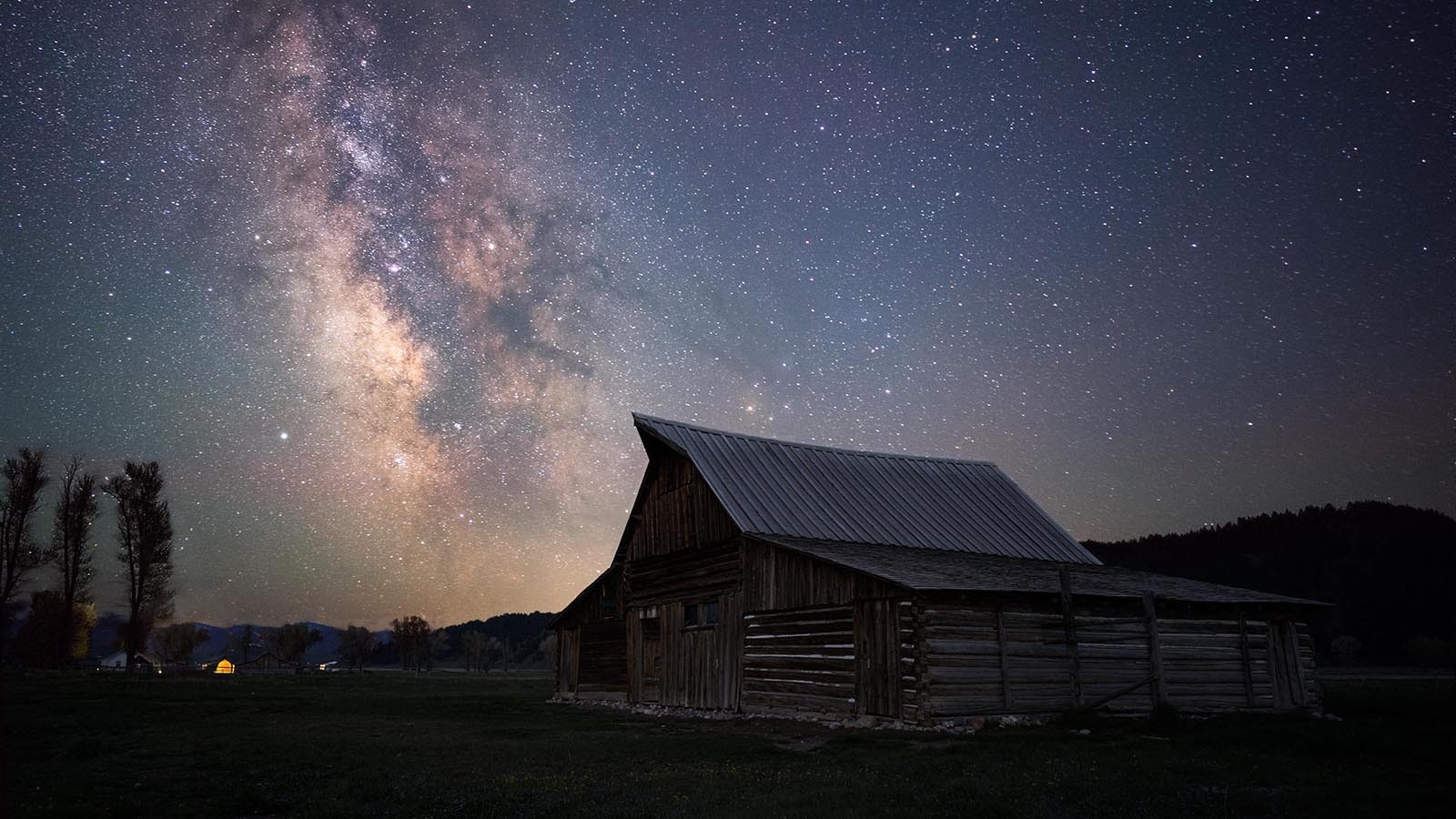 The Milky Way galaxy shines through the clear night sky over Teton County, Wyoming, near the Grand Tetons.