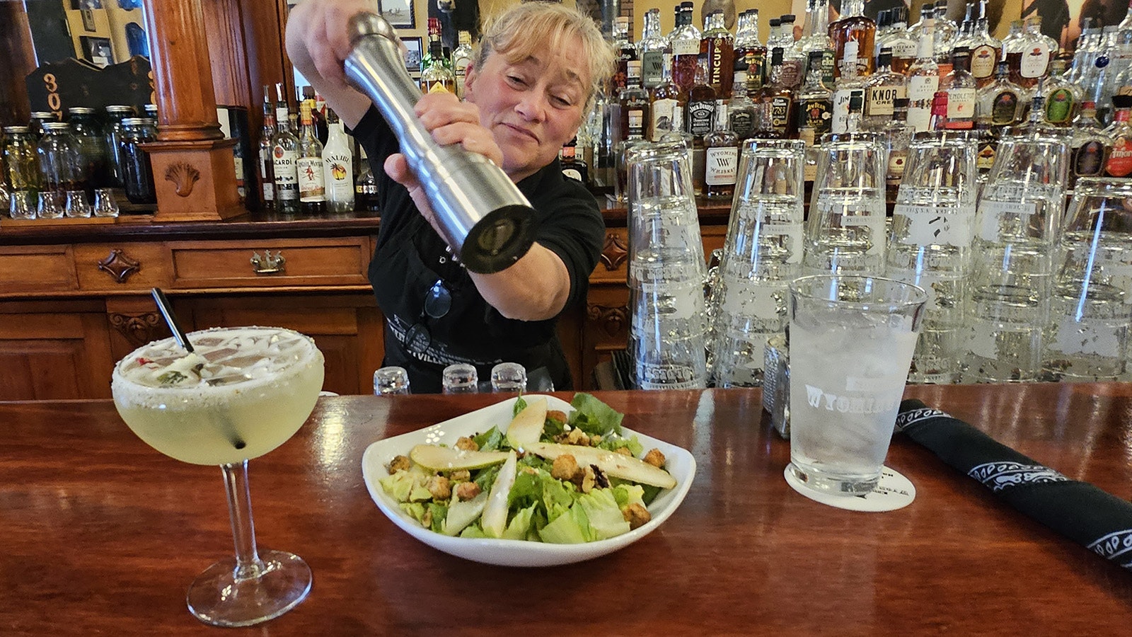 Christine Harmon puts pepper on the fresh pear and blue cheese salad at Miners and Stockmen's Steakhouse in Hartville.
