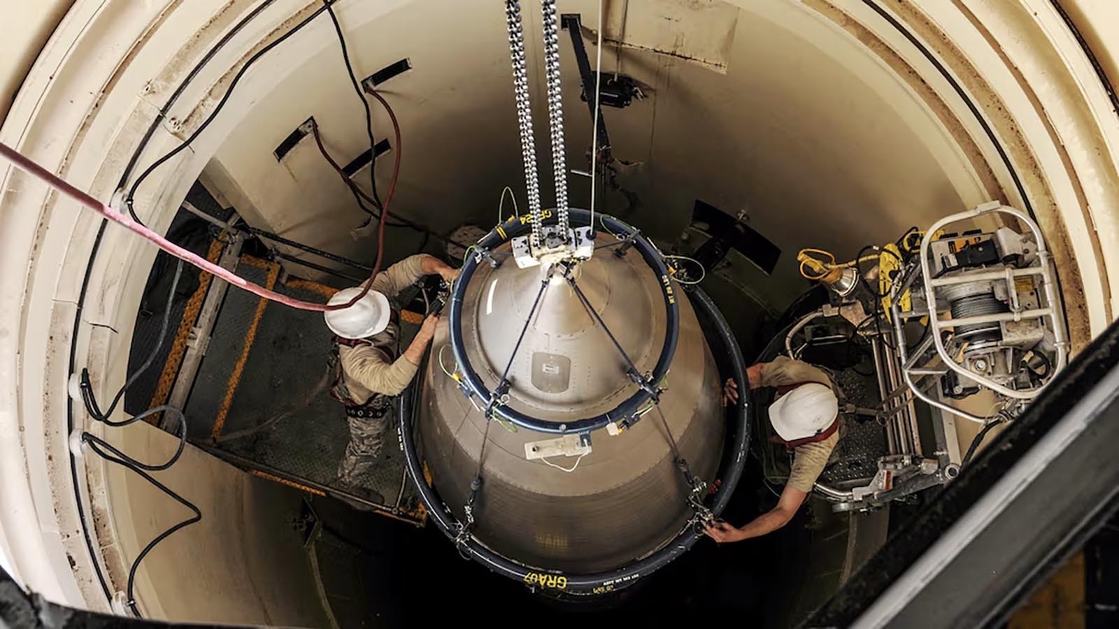 Technicians work on a Minuteman III intercontinental ballistic missile in a silo in this U.S. Air Force file photo. Upgrading to Sentinel missiles will require building new silos.
