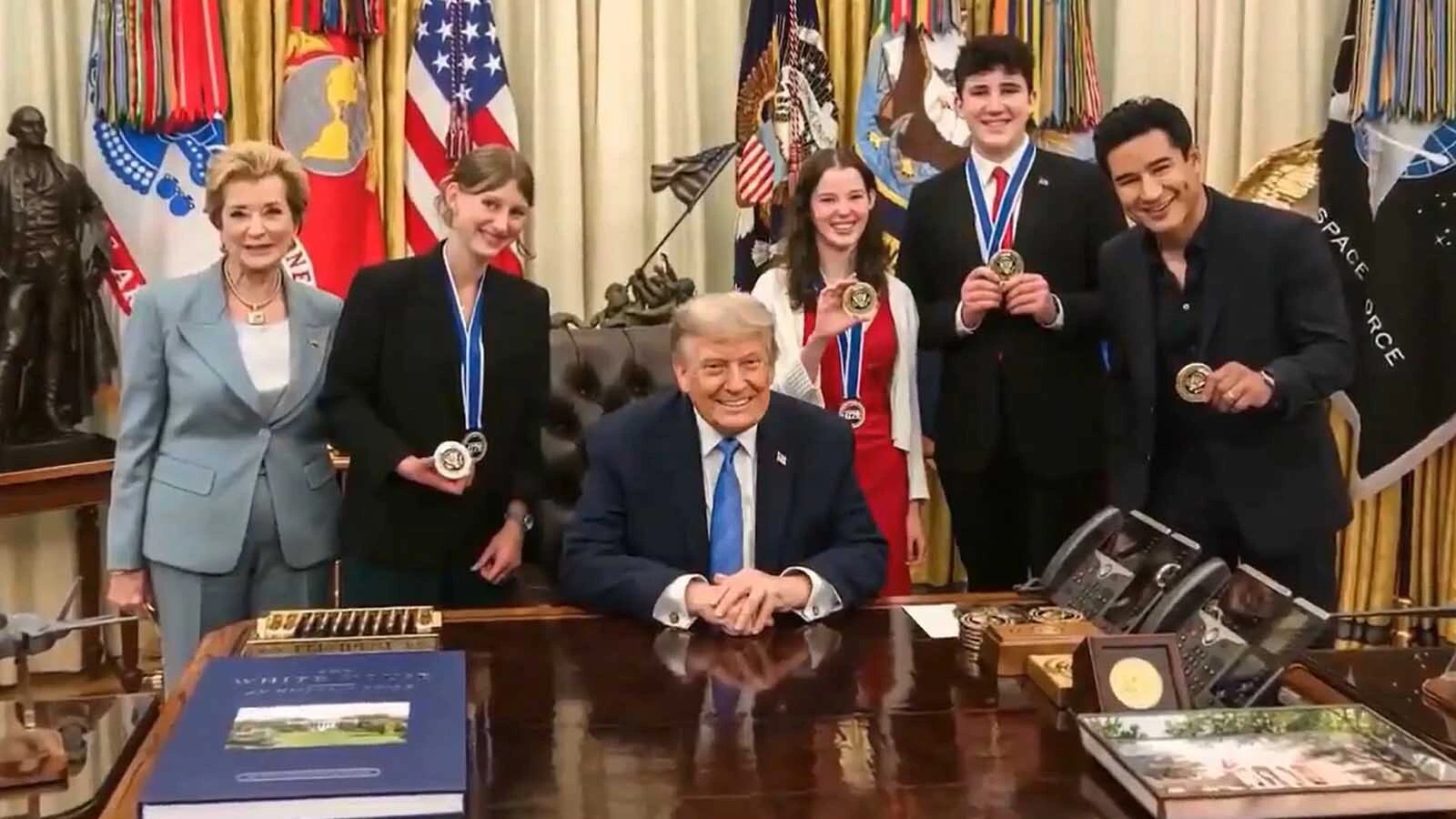Miriam Washut, second from left, stands next to President Donald Trump in the Oval Office.