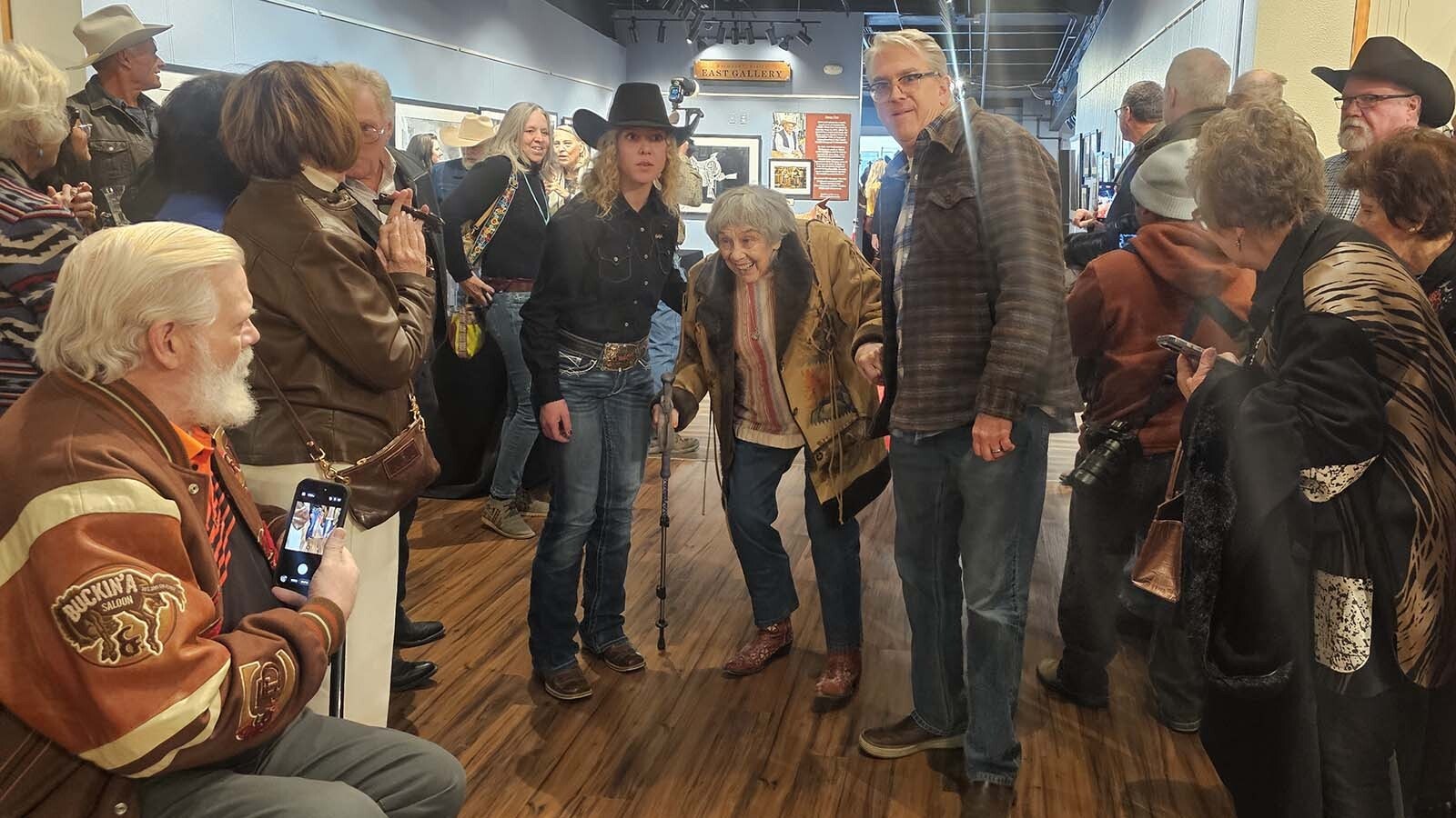 A Cheyenne Frontier Days Dandy escorts 1958 Miss Frontier Jeanette Tyrrell Daly across a red carpet into a ceremony honoring all past, present and future Miss Frontiers. Daly is the oldest living Miss Frontier.