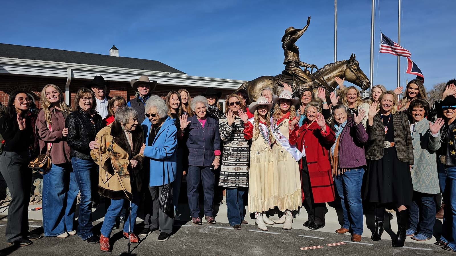 Miss Frontier gathers with members of the crowd, including other former Miss Frontiers, for a shot of them waving back at an adoring crowd.