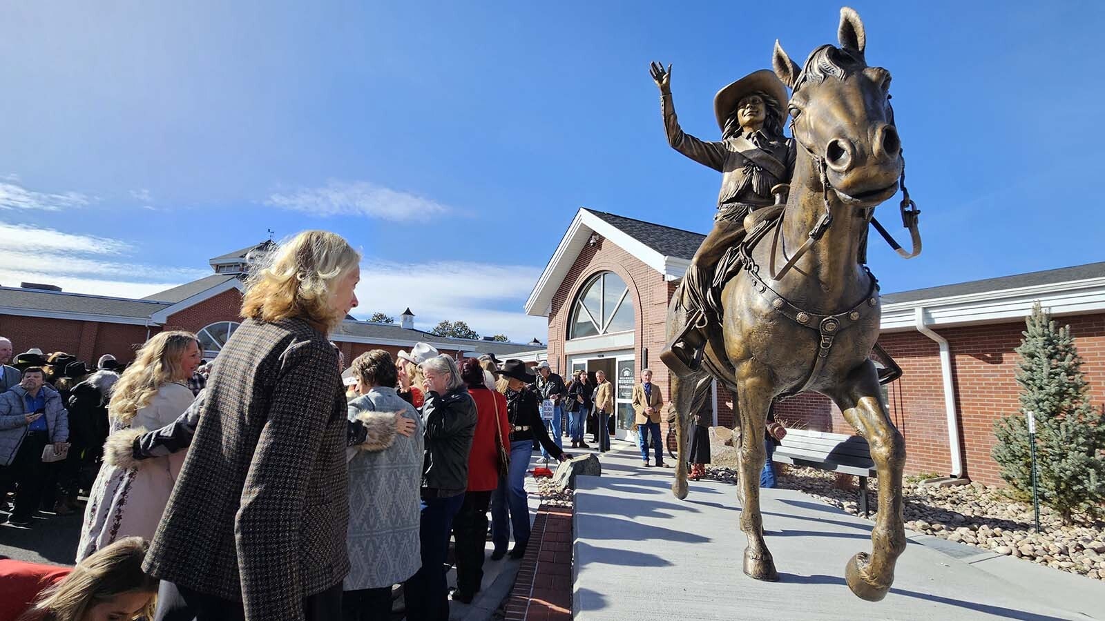 Miss Frontier perpetually waves at the entrance of the Old West Museum in Frontier Park.