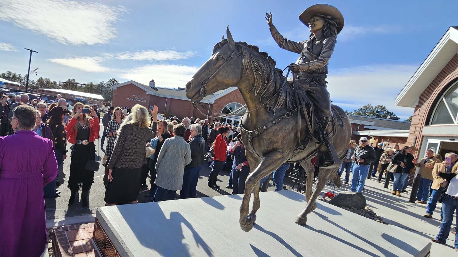 Miss Frontier perpetually waves at the entrance of the Old West Museum in Frontier Park.