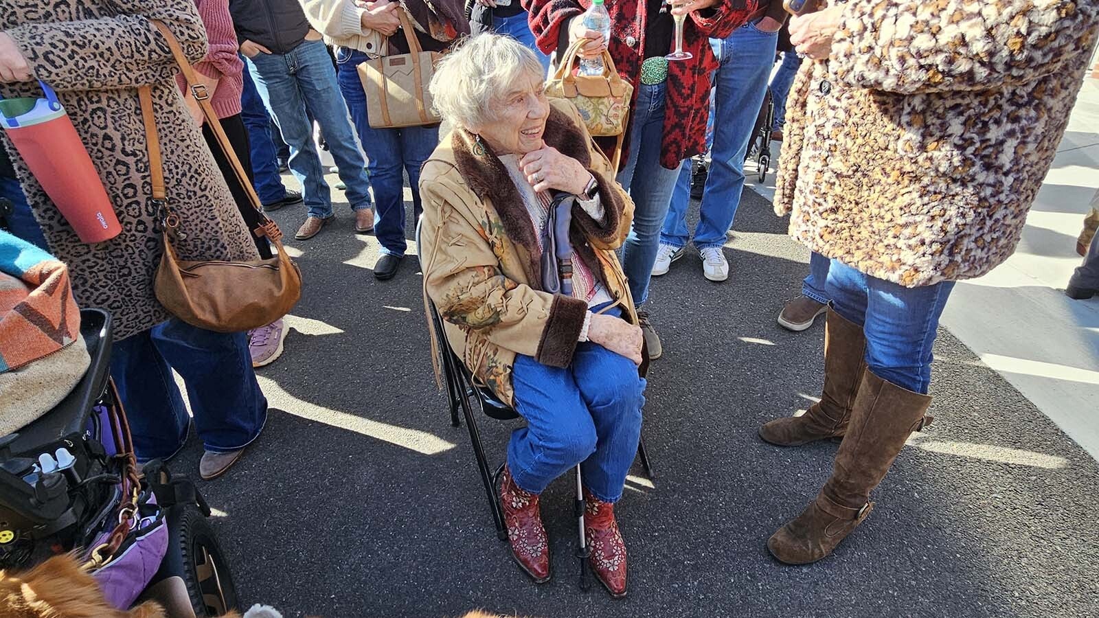 Jeanette Tyrrell Daly, seated, is surrounded by a crowd f well-wishers during the unveiling ceremony for Miss Frontier. Daly is the oldest living Miss Frontier, serving in the role in 1958.