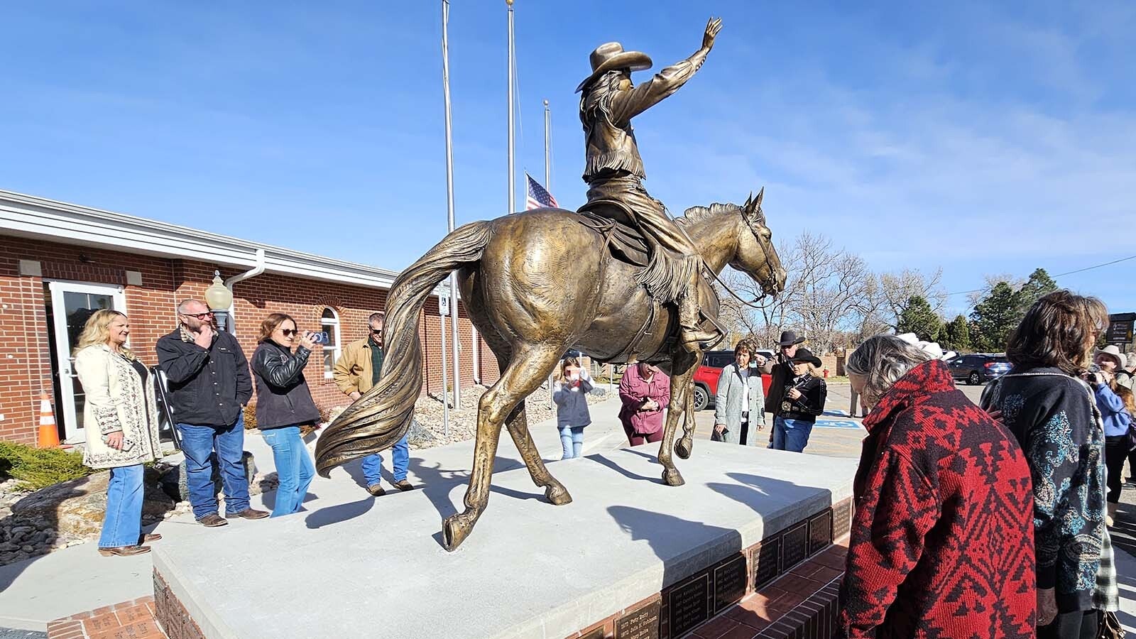 Miss Frontier, caught mid-ride, just as she might be during Cheyenne Frontier Days parade, perpetually waves at an adoring crowd in Frontier Park.