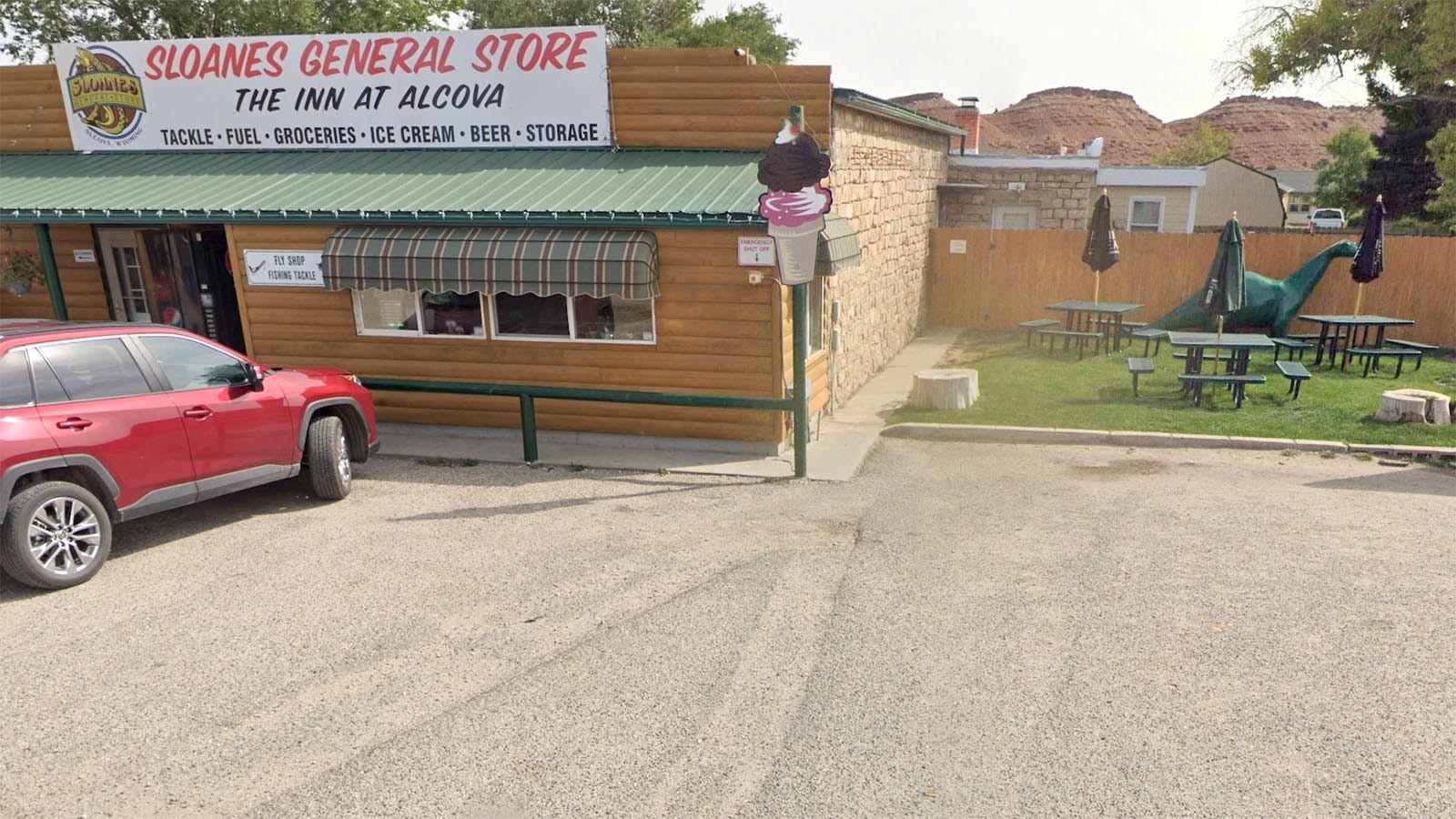 A Google Earth photo shows Dino inside the fenced picnic area in a warmer season.