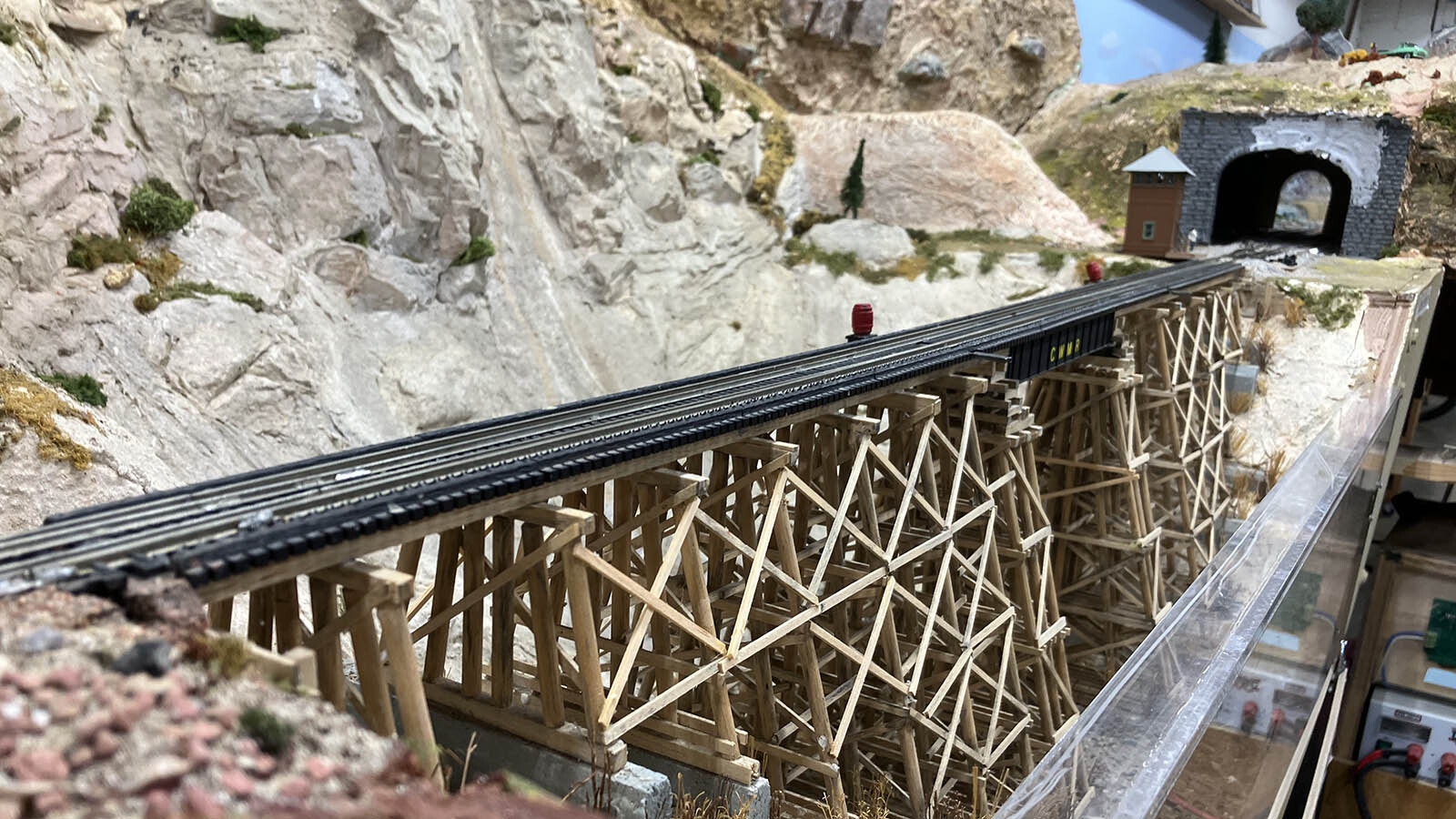 A former member of the club hand-made this timber bridge that stretches across a chasm on the model railroad club’s HO layout.