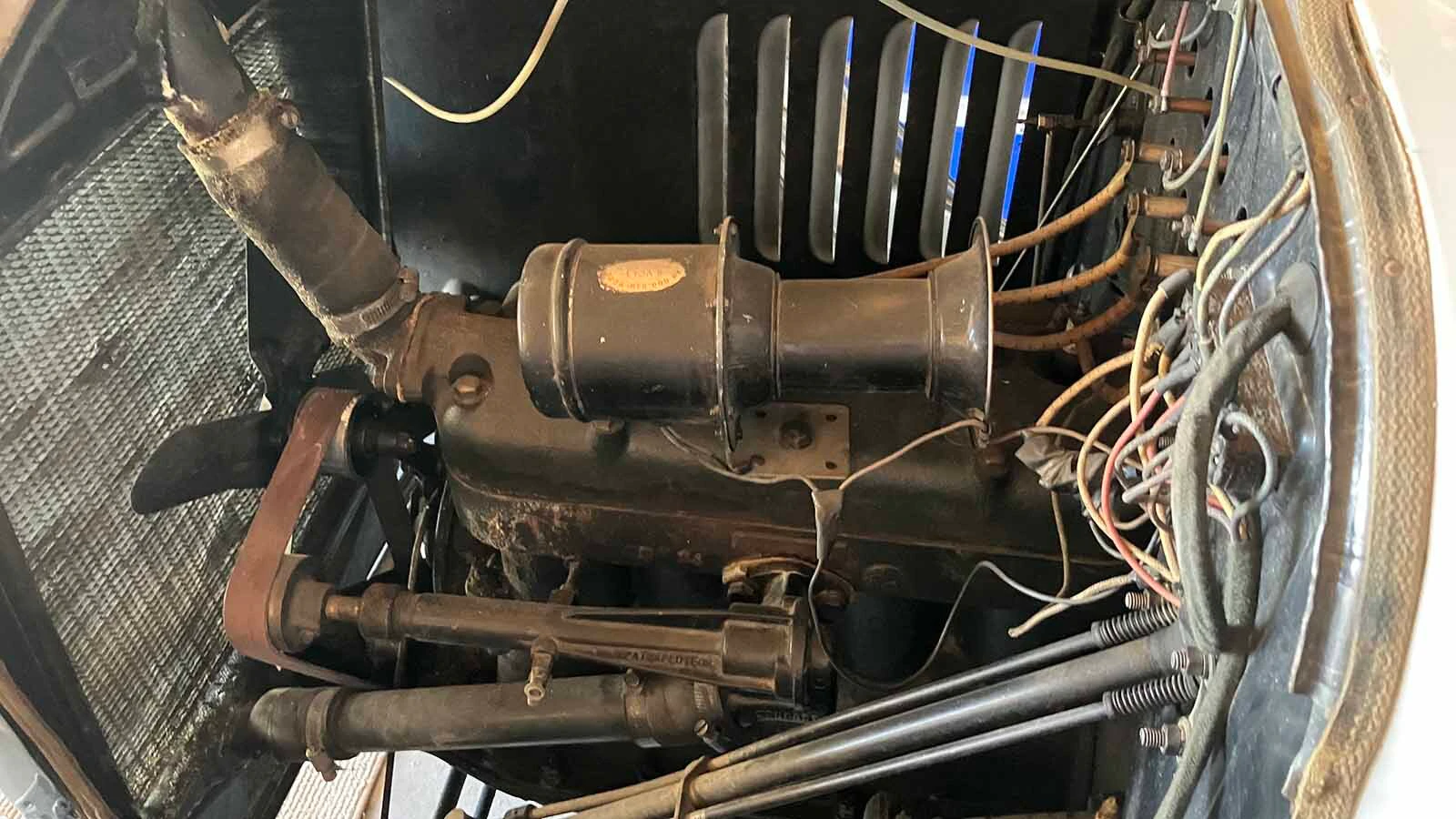 The little four-cylinder engine on the Model T with the tube used to cool the radiator.