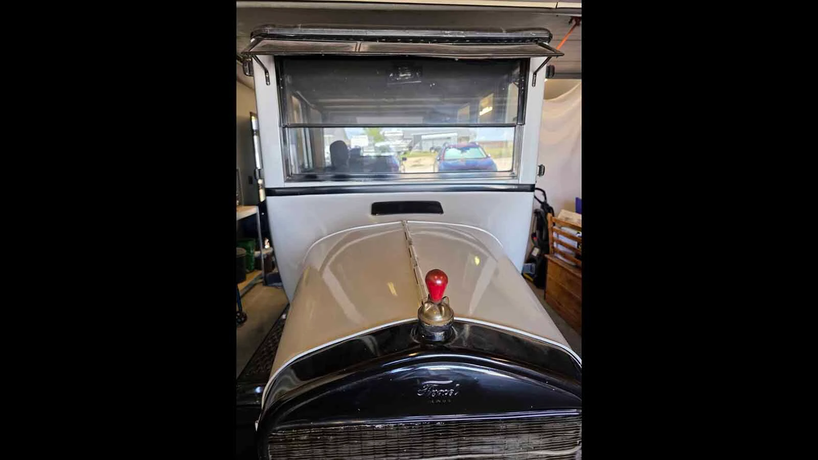 The Model T features a wooden bulb-like ornament and cap for its radiator.