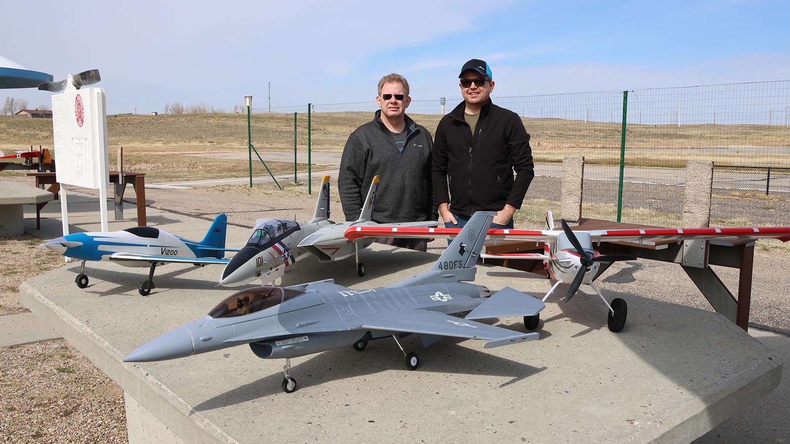 Father and son Bob, left, and Trevor Penor are pilots who fly private jets around the nation and beyond. Trevor brought his dad to the club on a recent day as he planned to fly his new F-14, second from left. He also owns the other planes.