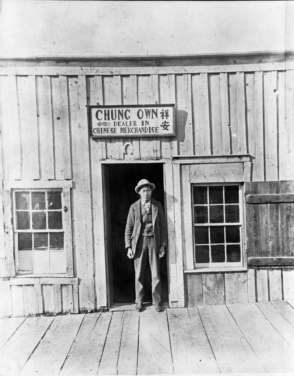 An unidentified man in front of Chung's Own store in Virginia City, Montana, circa 1896-1905.