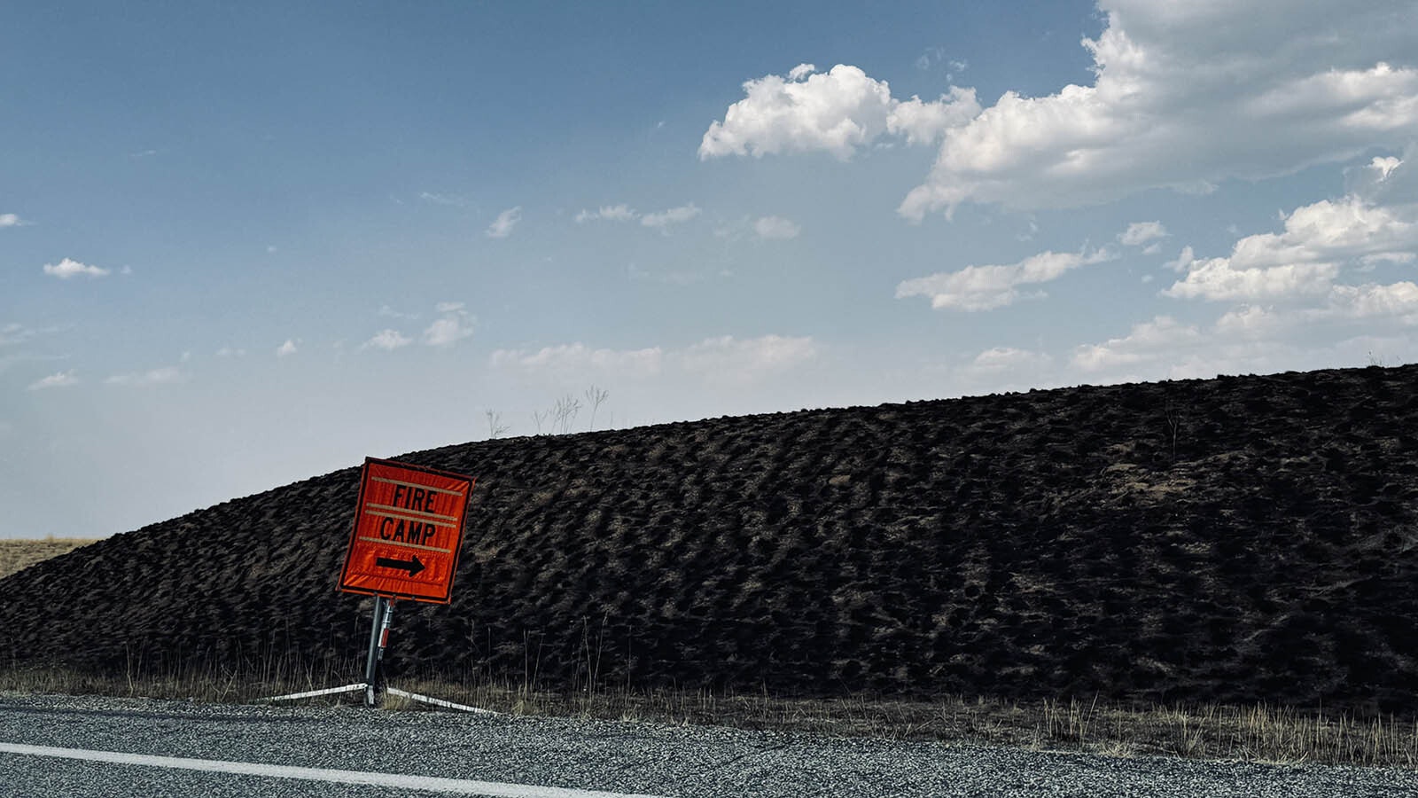 A sign points the way to the fire camp in the Tongue River Reservoir State Park for firefighters fighting the Remington Fire off Montana State Route 314 in southeastern Montana.