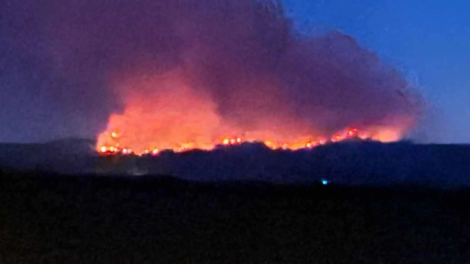 The Moonshine Fire burning southwest of Wheatland glows overnight as seen from Amy LeSatz's home about 14 miles east.