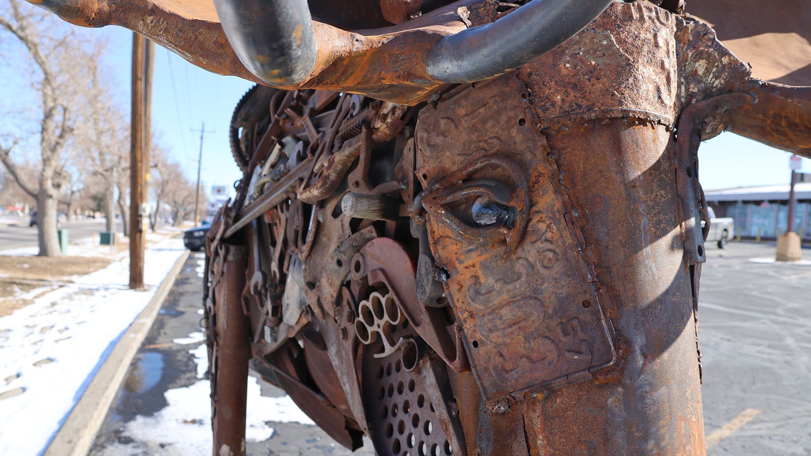 A 1957 Wyoming license plate helps make up the head of the sculpture called “Holy Smokes.” The artist’s signature item, brass knuckles made out of steel, can also be seen.