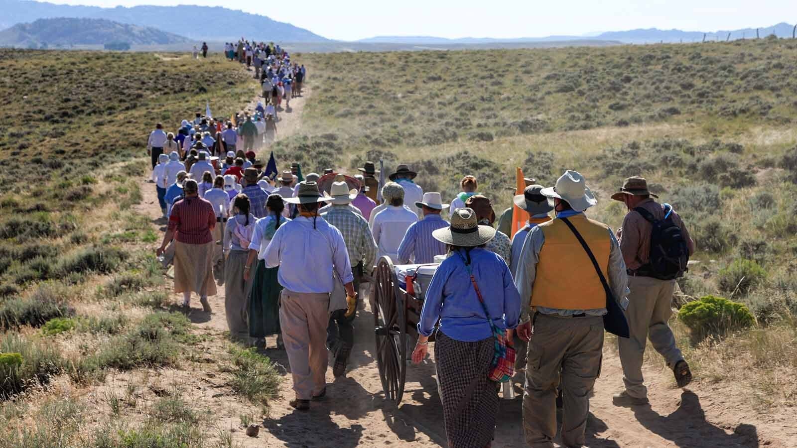 Members of the Church of Jesus Christ of Latter-day Saints walk along the Wyoming Mormon Trail near Lander, reenacting the trek of their forbearers who passed through during the 1800s while journeying toward Salt Lake City.