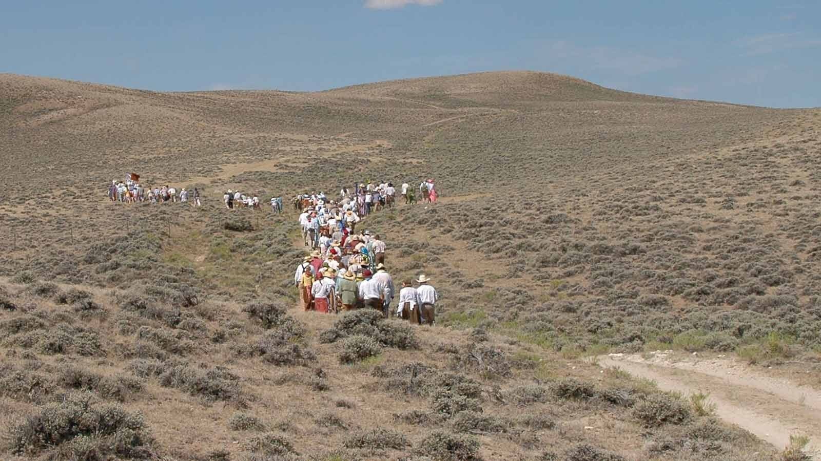 Members of the Church of Jesus Christ of Latter-day Saints walk along the Wyoming Mormon Trail near Lander, reenacting the trek of their forbearers who passed through during the 1800s while journeying toward Salt Lake City.