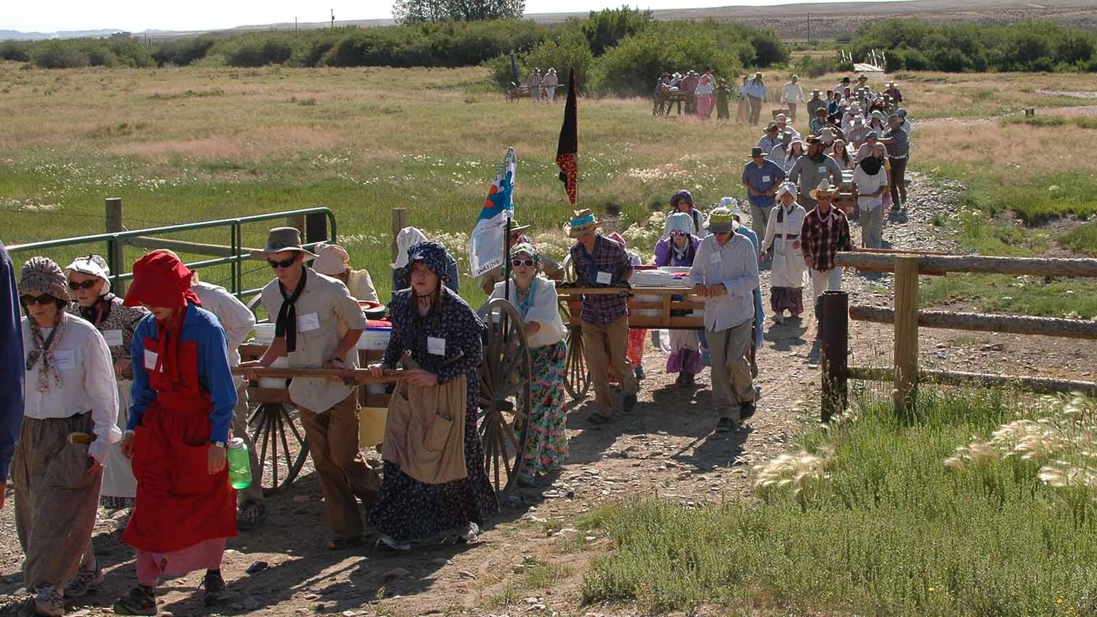 Members of the Church of Jesus Christ of Latter-day Saints walk along the Wyoming Mormon Trail near Lander, reenacting the trek of their forbearers who passed through during the 1800s while journeying toward Salt Lake City.