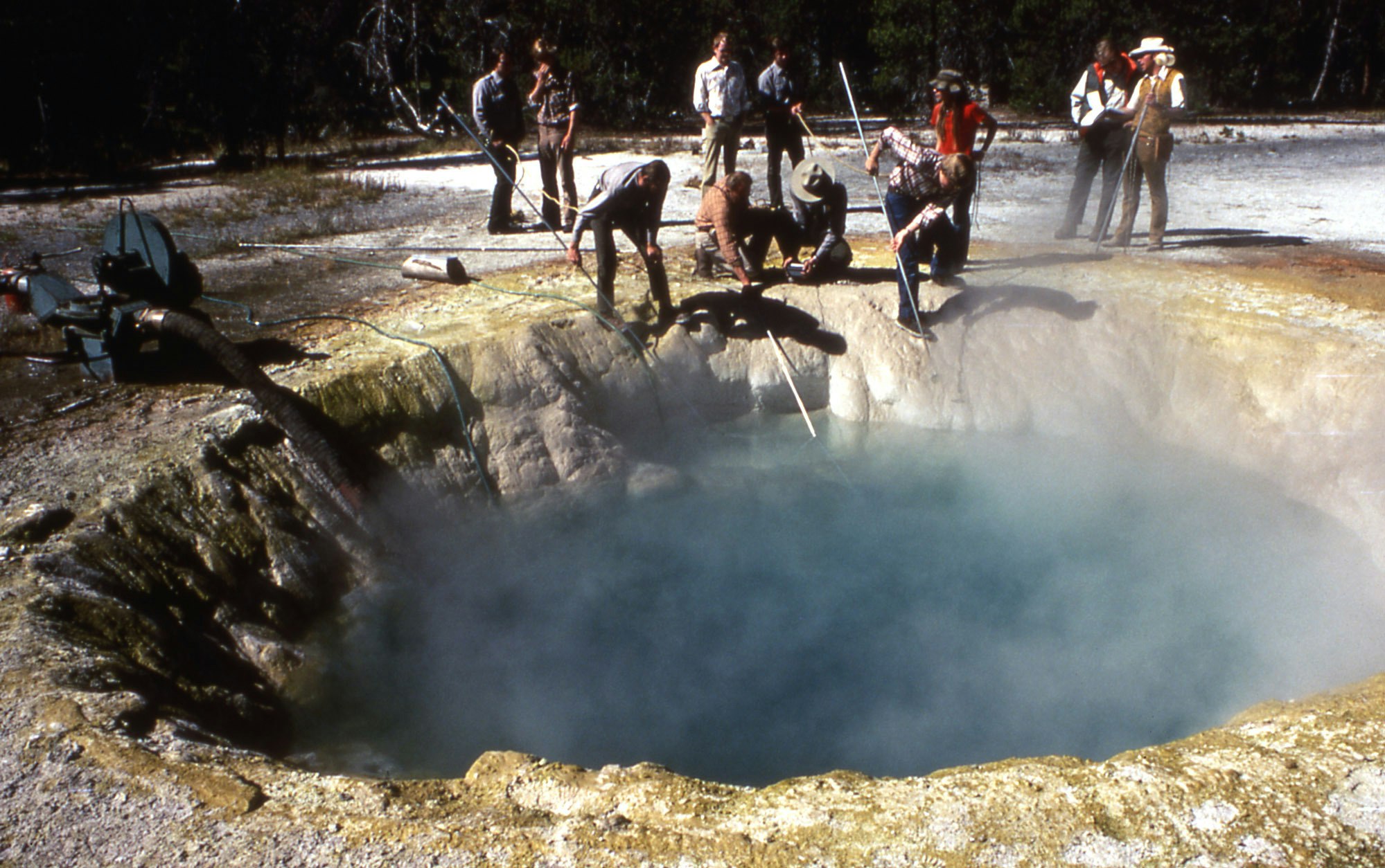 Rangers attempting to clean trash out of Morning Glory Pool in September 1975.