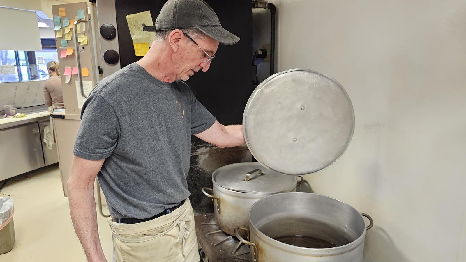 Bill Snow, owner of Mort's Bagels in Cheyenne, lifts the lid to one of two pots he uses to boil bagels prior to the shop's 6 a.m. opening.