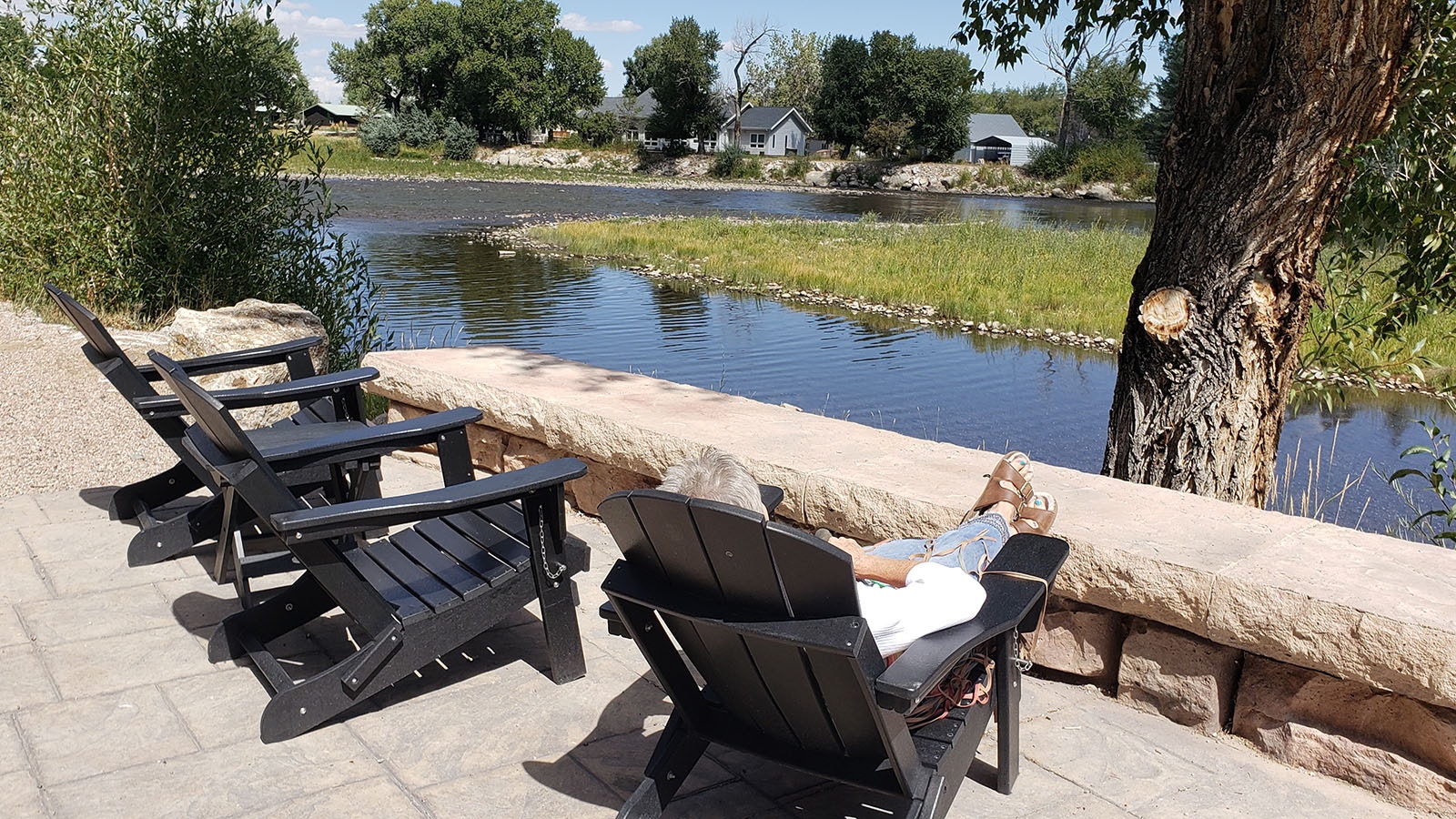 A row of seats offers a quiet spot by the river for taking a nap.