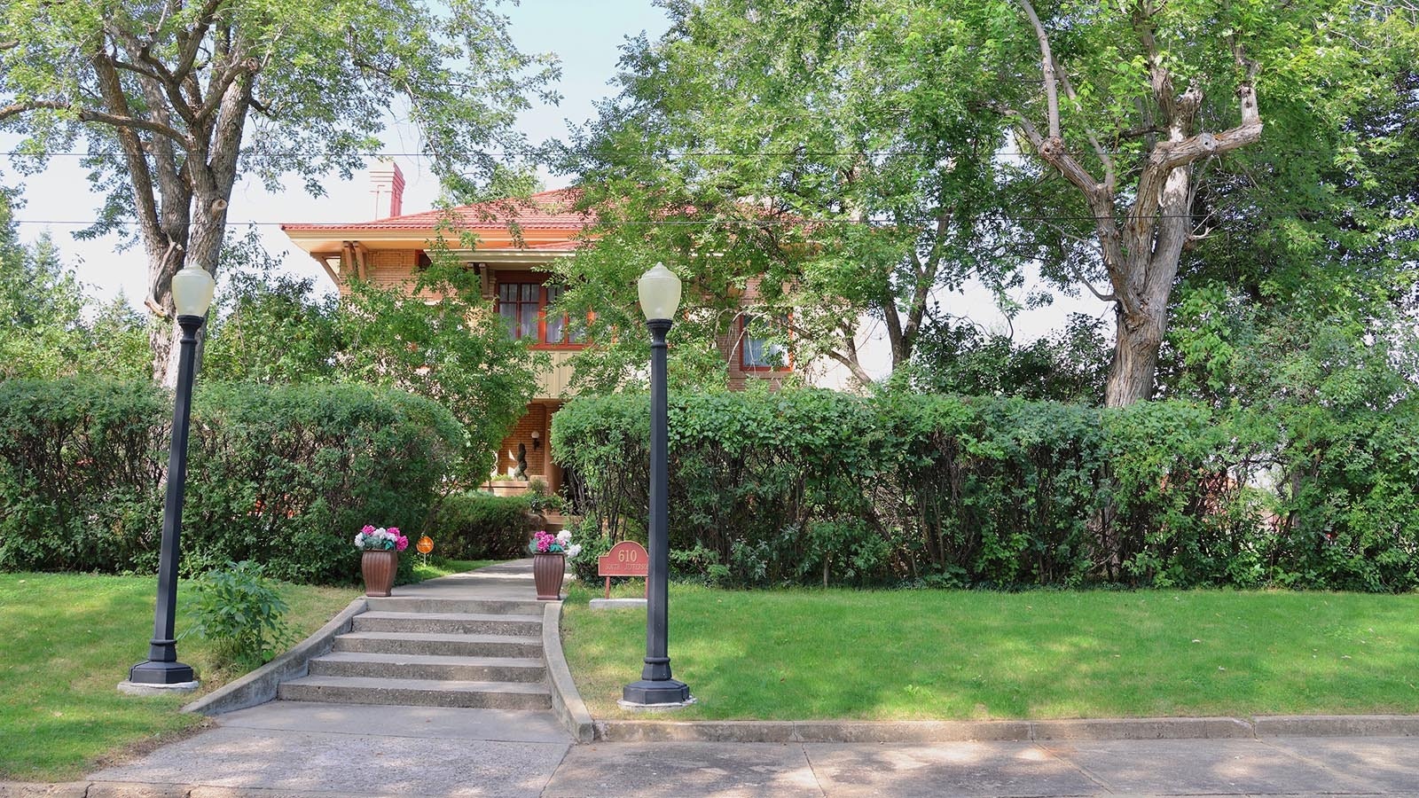 Original 100-year-old hedges provide privacy for the 112-year-old Sheridan mansion at the corner of College Avenue and South Jefferson Street.