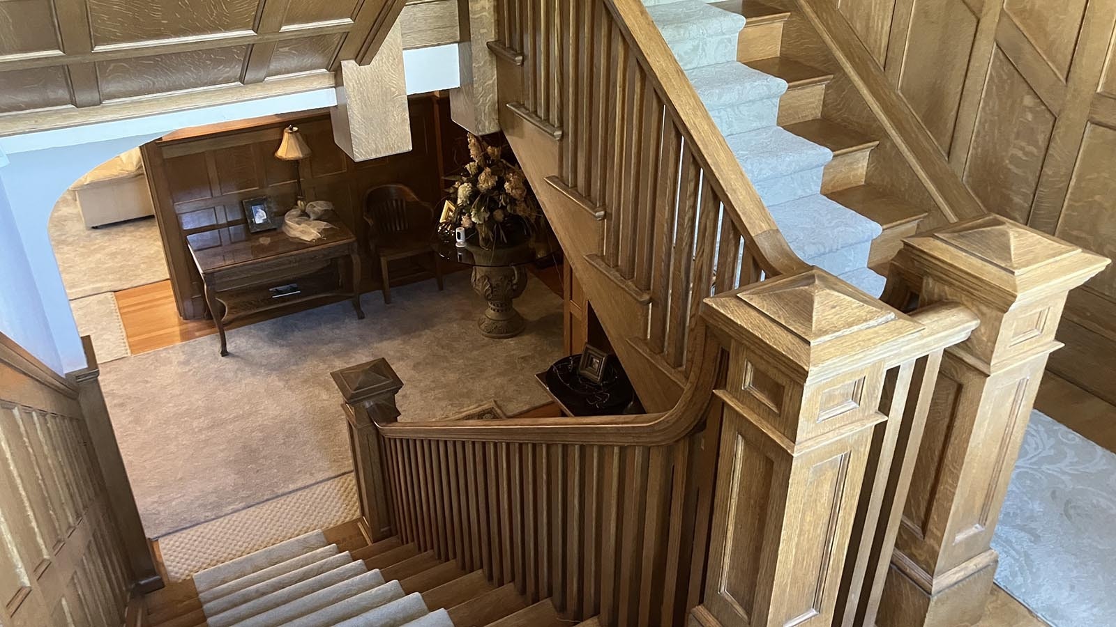 Beautiful woodwork on stairs and walls leads up from the first to the second floor.