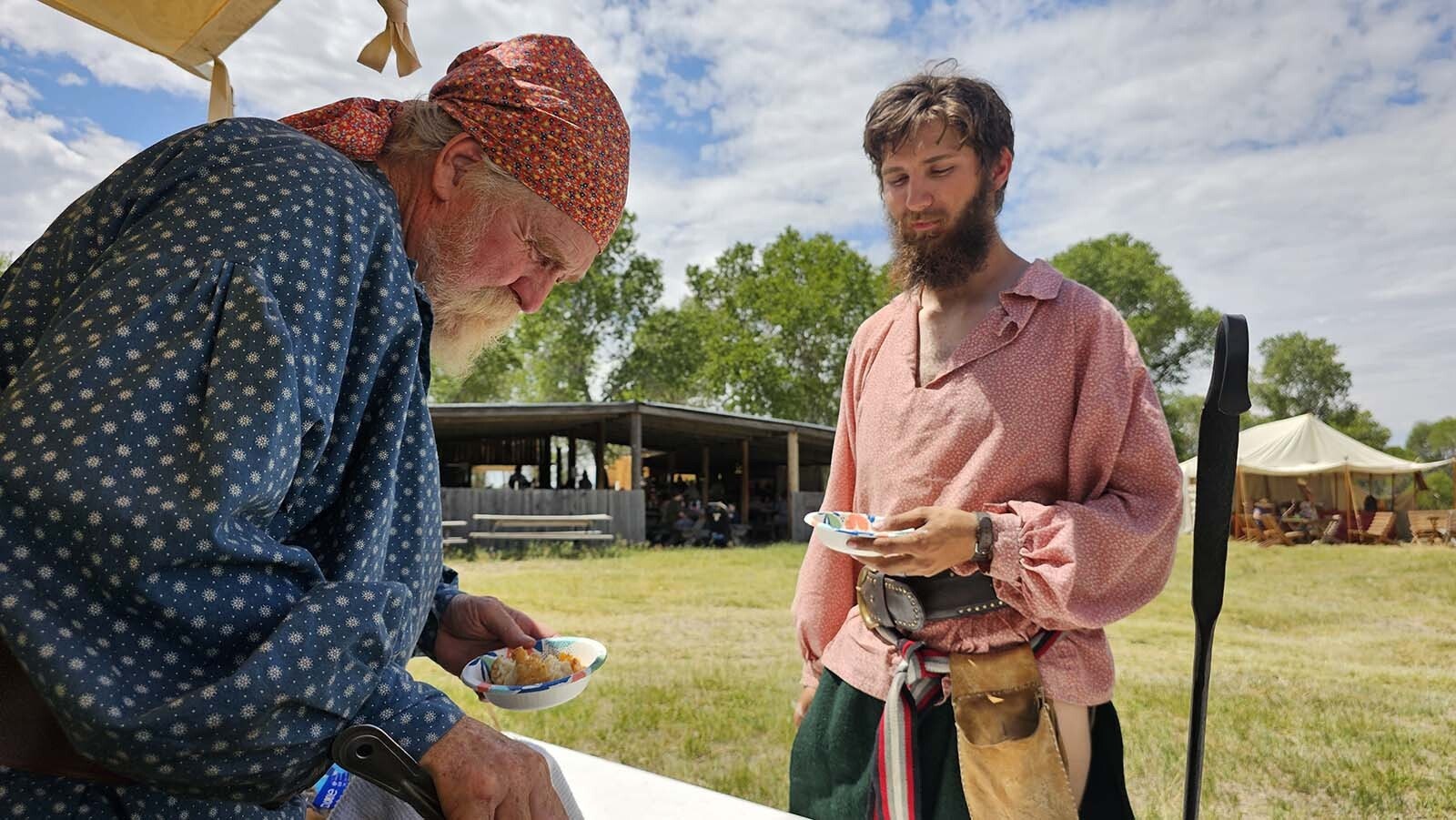 Paul Vance, left, dishes up a peach pie cooked in a dutch oven during the 1838 Riverton Rendezvous, going on now through July 6.