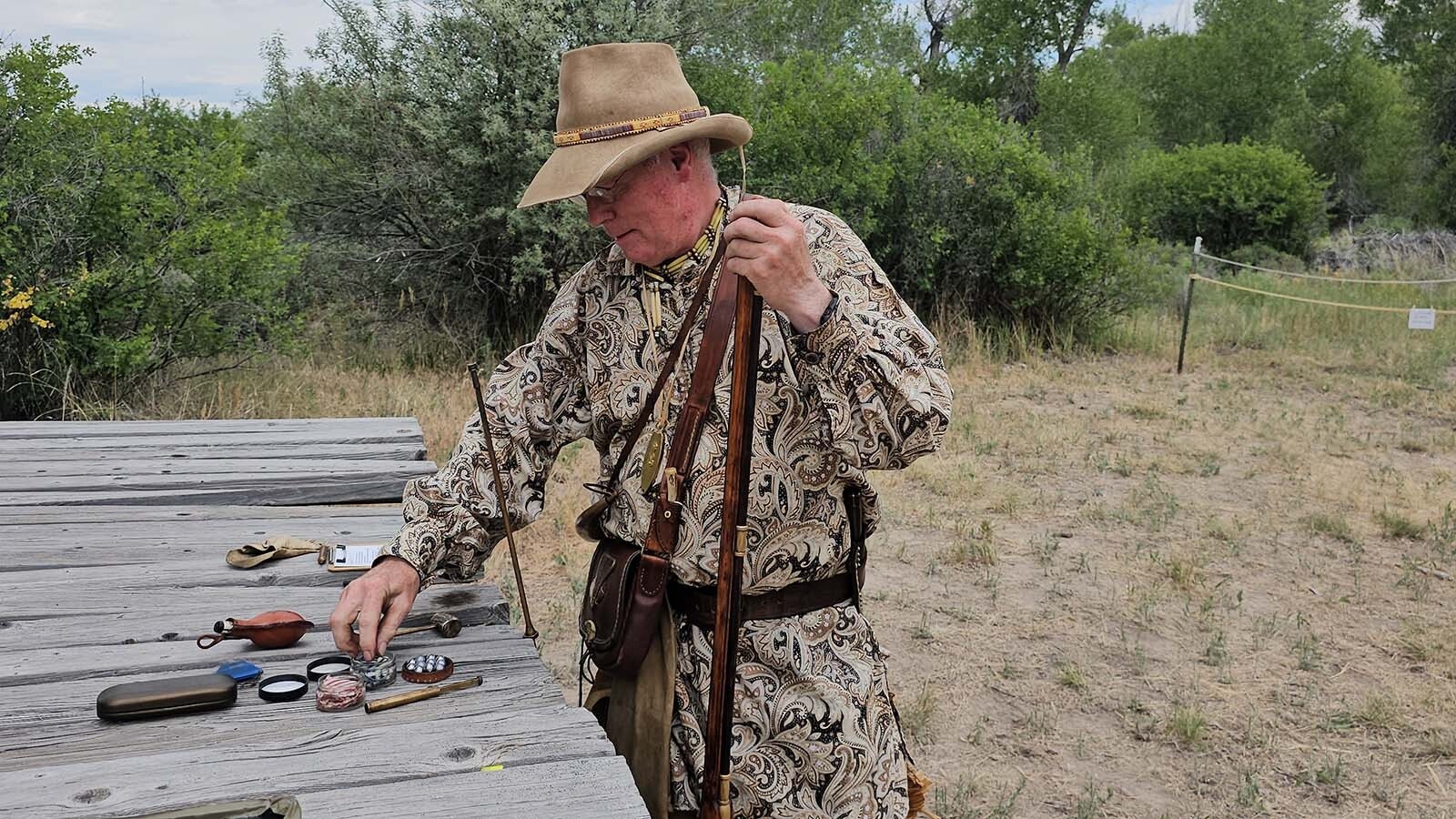 Broken Water prepares his rifle for shooting at the 183i Rendezvous in Riverton.