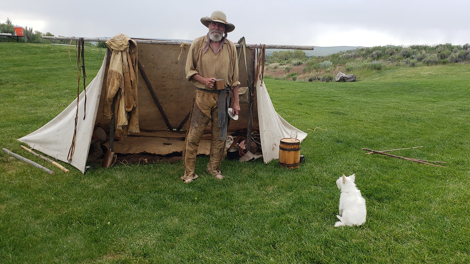 George Korhel dressed in buckskin clothing he made himself stands in front of his camp during the recent Green River Rendezvous.