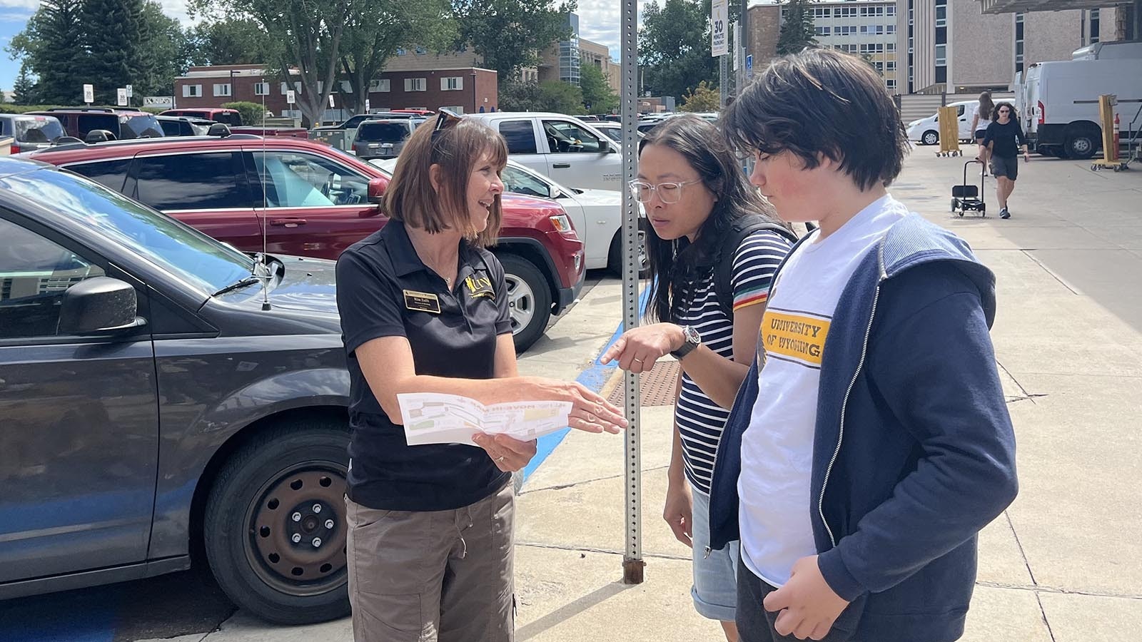 Kim Zafft, director of residence life at the University of Wyoming, helps new students navigate campus on move-in day Friday.