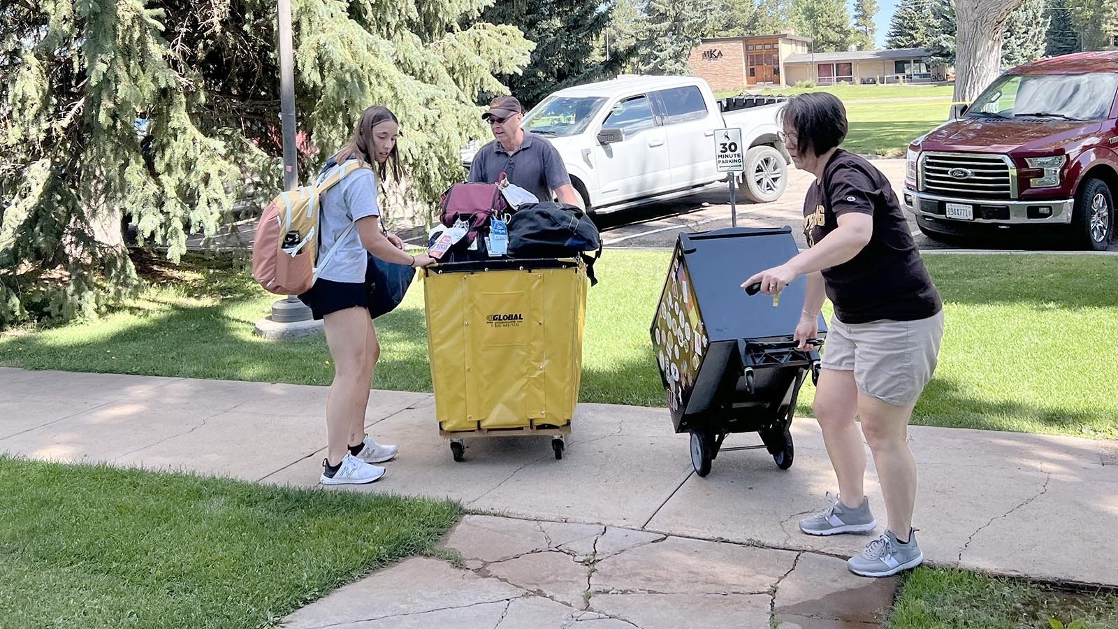 : Brad and Sanda Salverson help their daughter Ava move into the dorm at the University of Wyoming in Laramie on Friday.