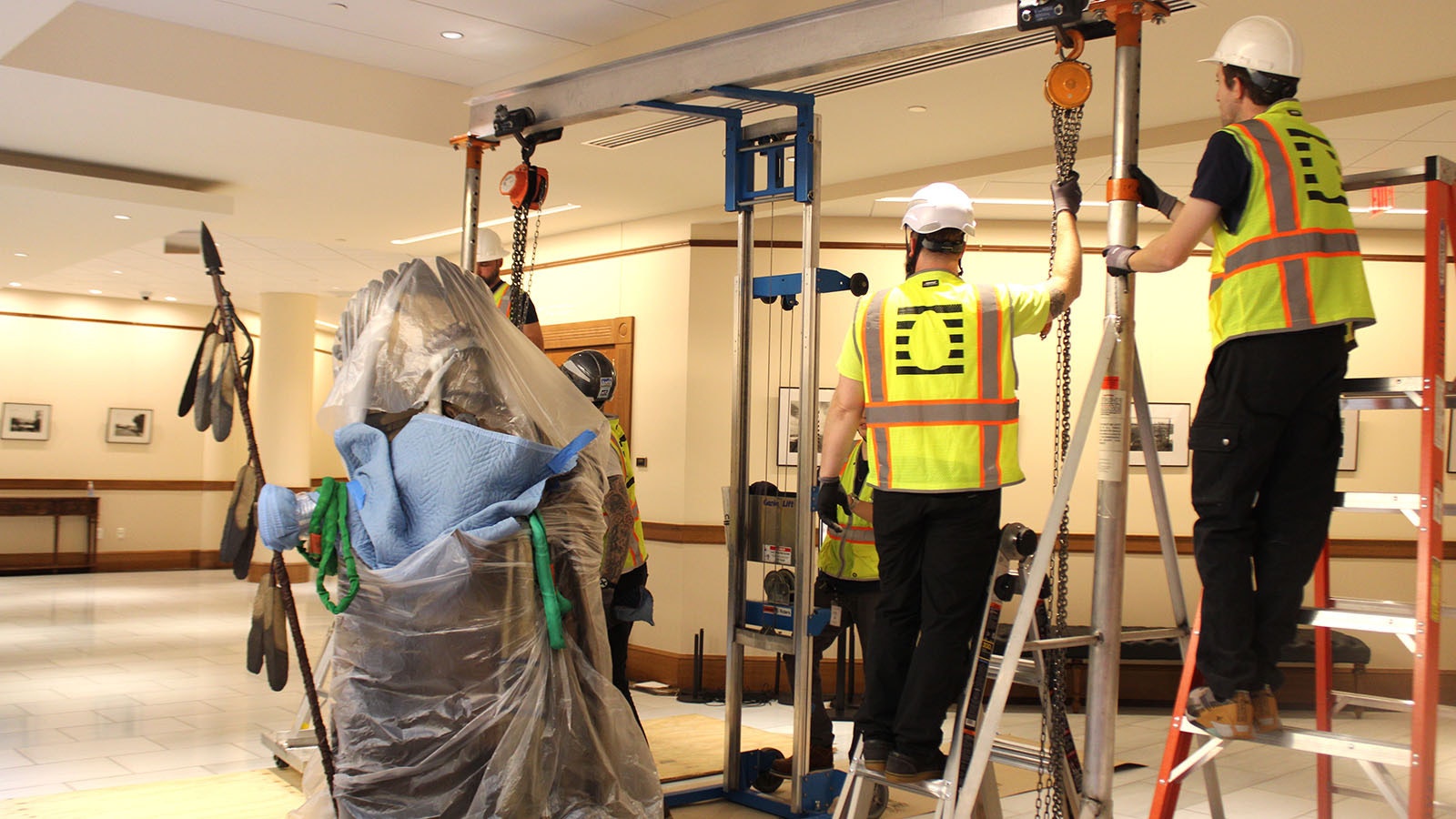 Workers prepare to move the Chief Washakie statue at the Wyoming Capitol.