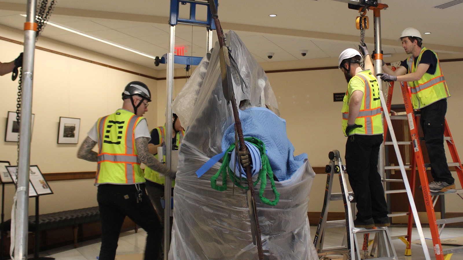 Workers prepare to move the Chief Washakie statue at the Wyoming Capitol.