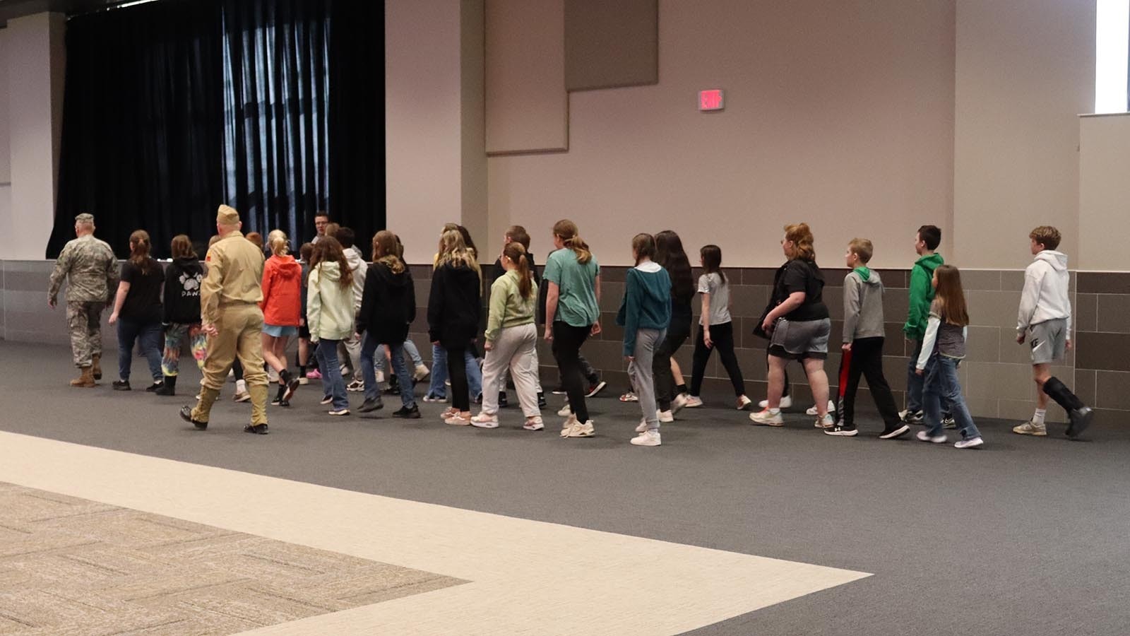 1st Sgt. Paul Bennick marches students in the Entry to Service station.