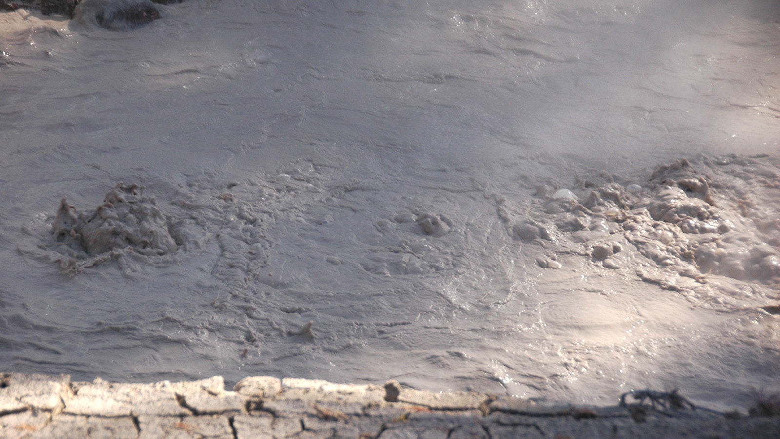 Nobody knows when or how "Infrastructure Spring" appeared in Yellowstone's West Thumb Geyser Basin, but it's one of the most unique thermal features in the park. The water that created the mudpot flows through old pipes.