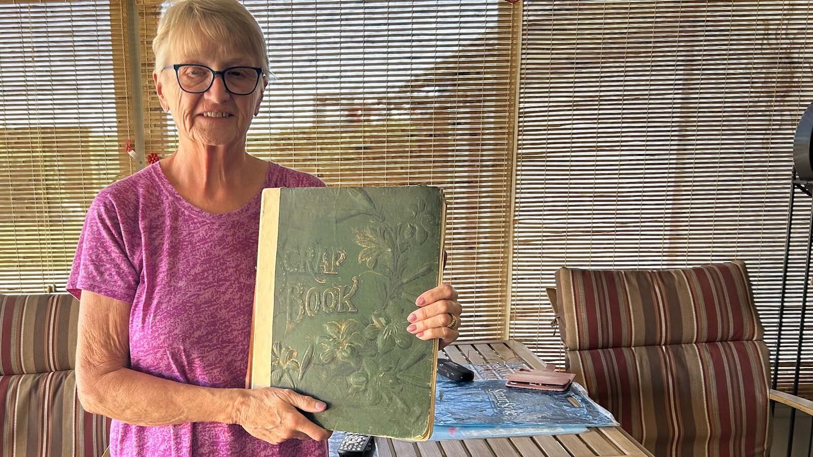 Kathy McKinzie, the great-niece of Gilbert "Muggsy" Schoel, holds the family scrapbook of the fighter who made a name in the boxing world at the turn of the last century.
