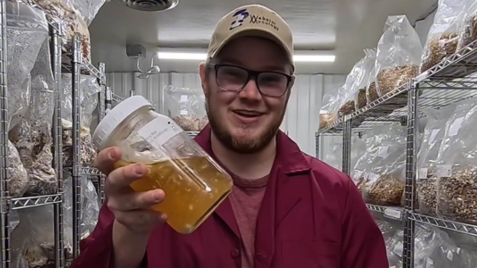 Austin Webster, aka the Evanston Mushroom Guy, stands in a grow room while making an instructional video on how to raise mushrooms.