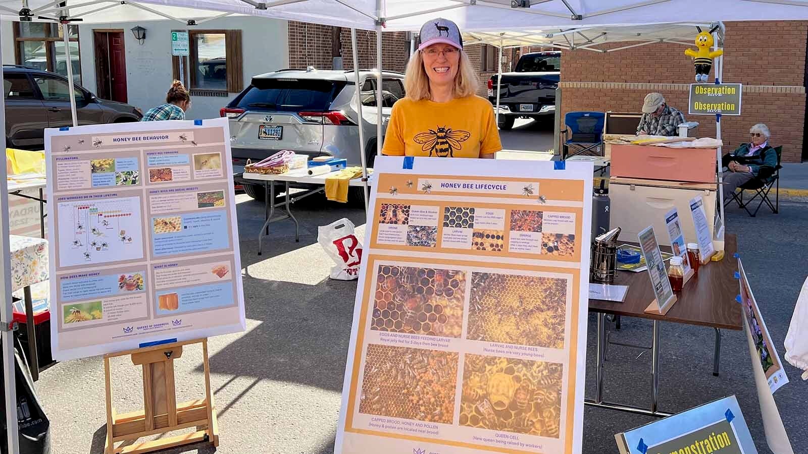 Susan Frost is a retired NASA research scientist who took up beekeeping for a hobby and later created her own business Queens of Goodness. The Lander resident is pictured with informational posters she made for National Honey Bee Day.