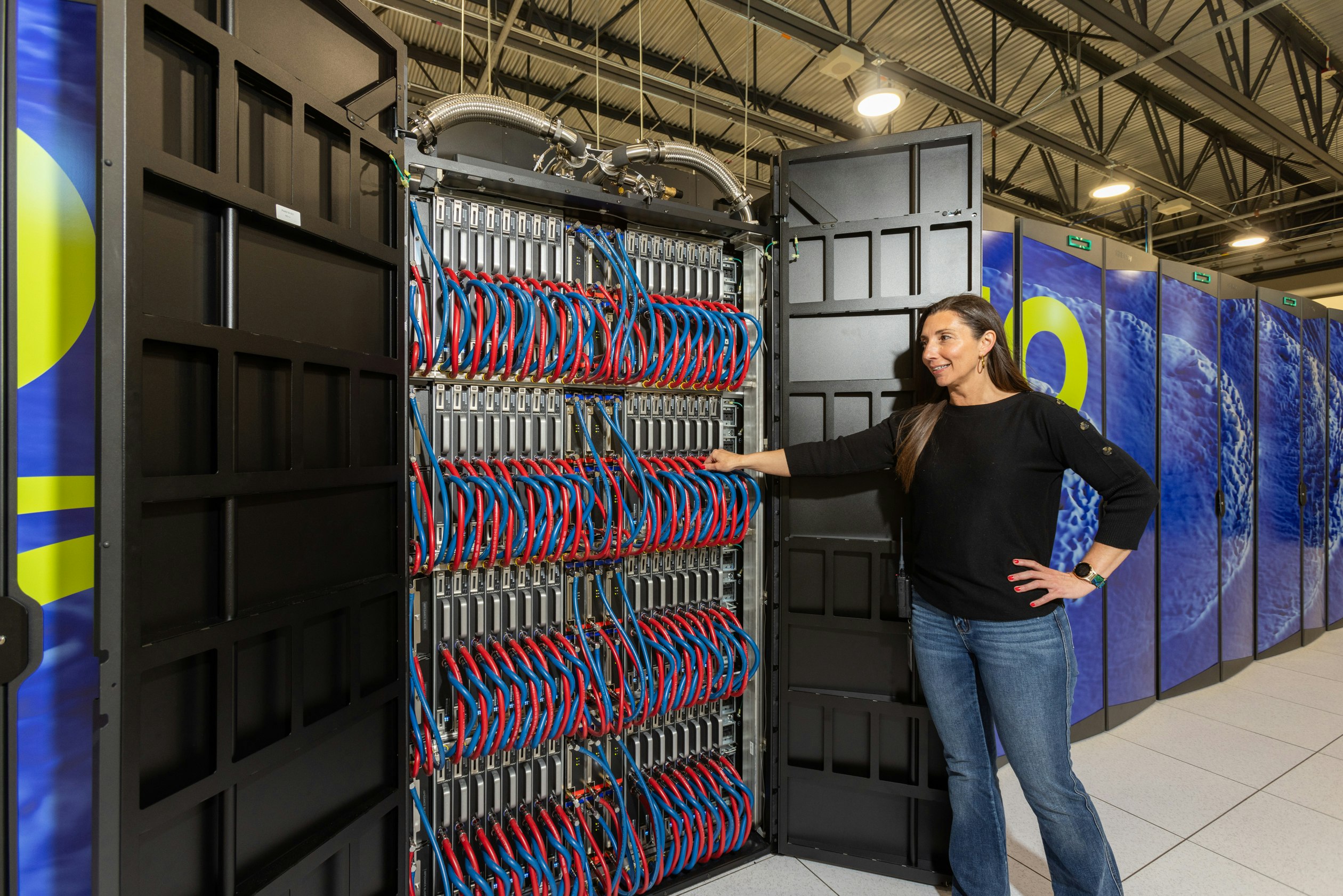 The research happening at Wyoming’s supercomputer facility in Cheyenne is about much more than climate change. It’s led to fundamental breakthroughs that have made many pursuits safer, ranging from fighting wildfires to flying jets. Above, Summer Wasson in a file photo demonstrates where cold water flows into the Drencho supercomputer to cool it.