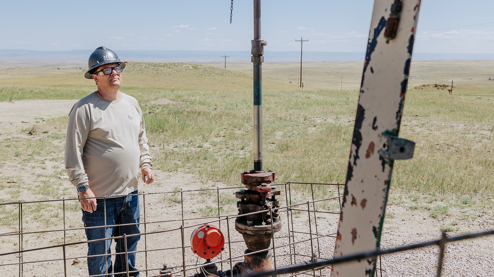 Nathan McLeland inspects a pumpjack on a stripper well in Weston County.