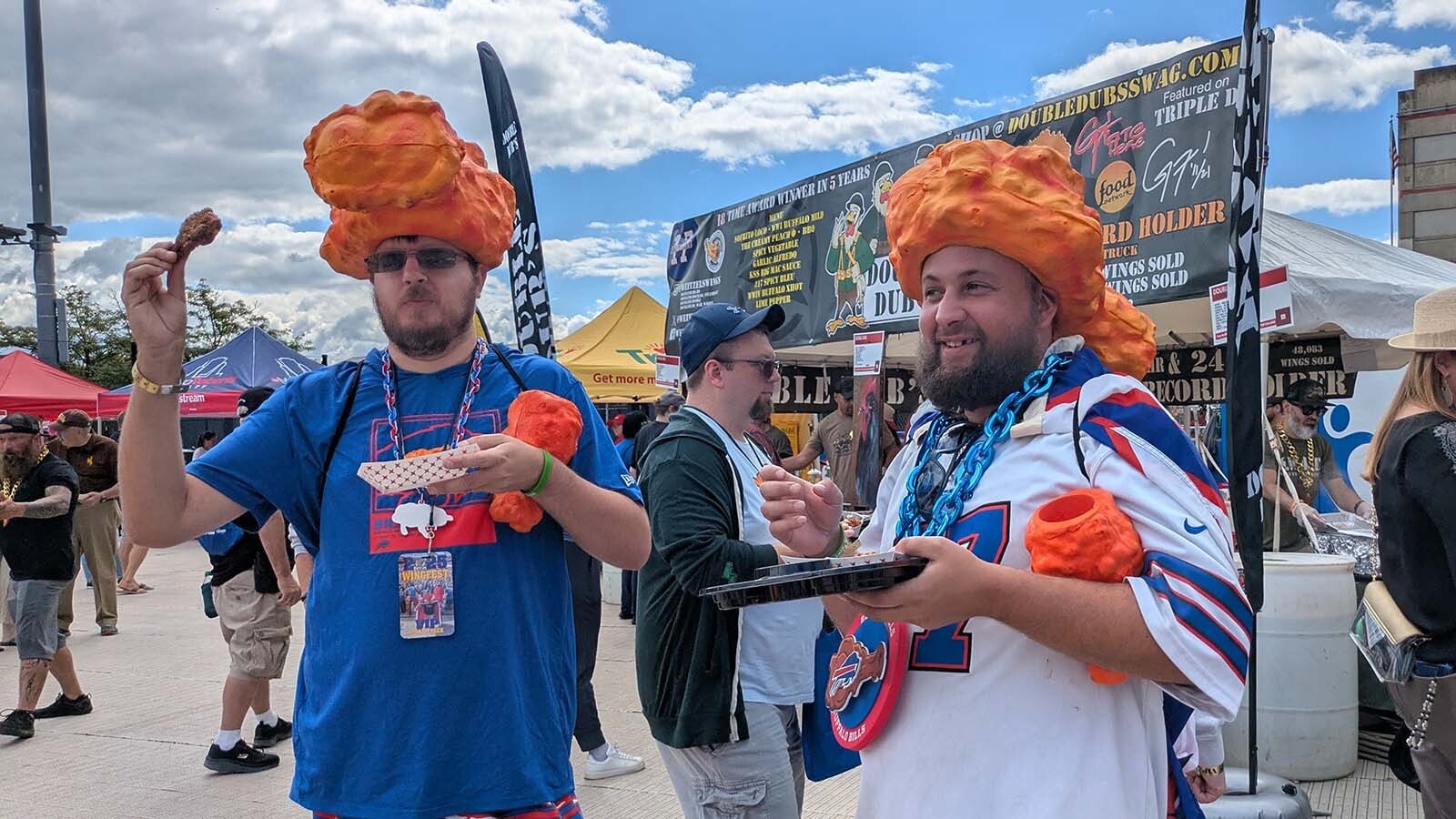 Richard Zawistowski, left, and Michael Lonergan bought VIP tickets to this year's festival which included some perks like those wing-shaped koozies they're holding.