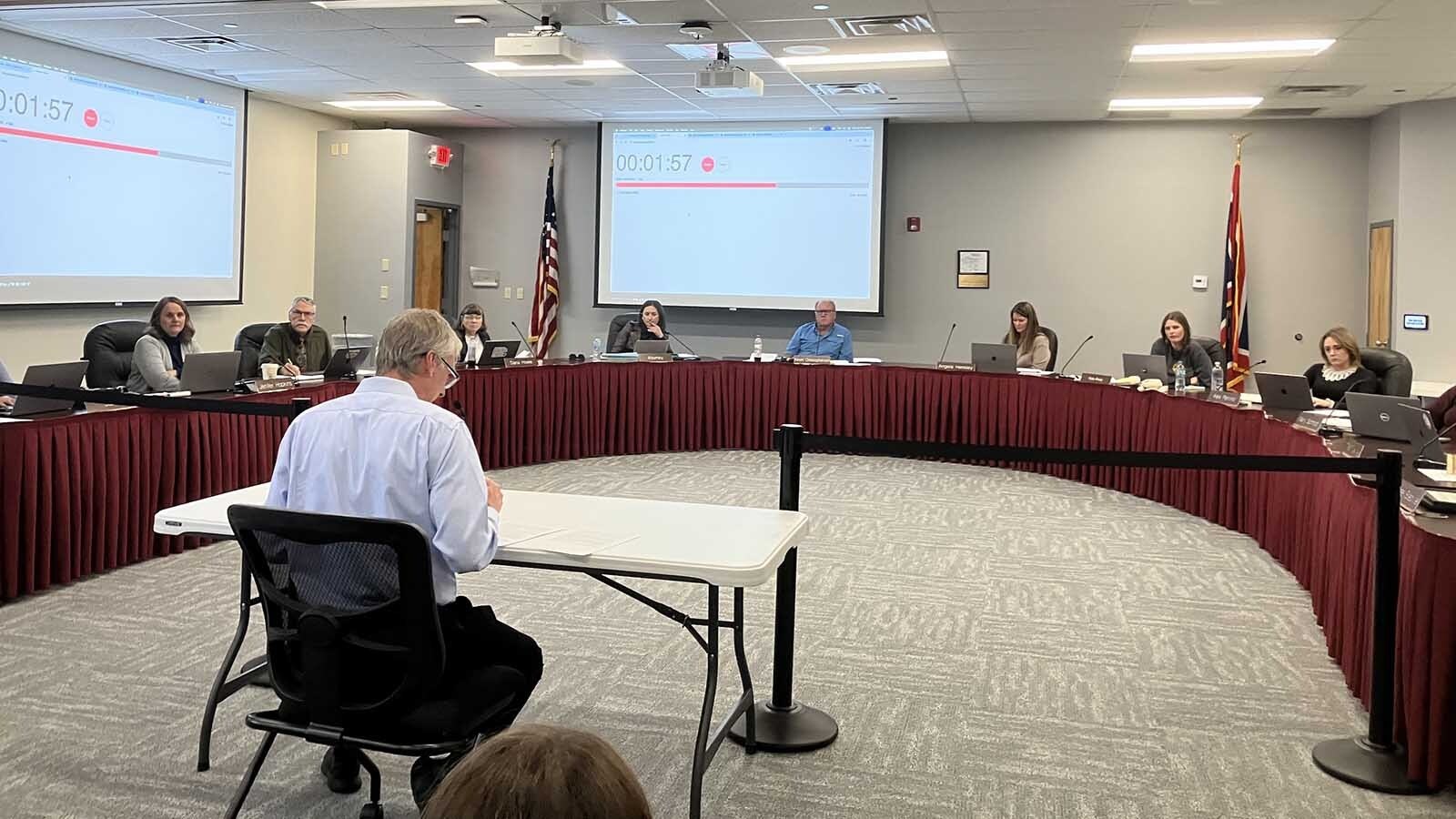 Eric Nelson addresses the school board about the closure of Woods Learning Center.