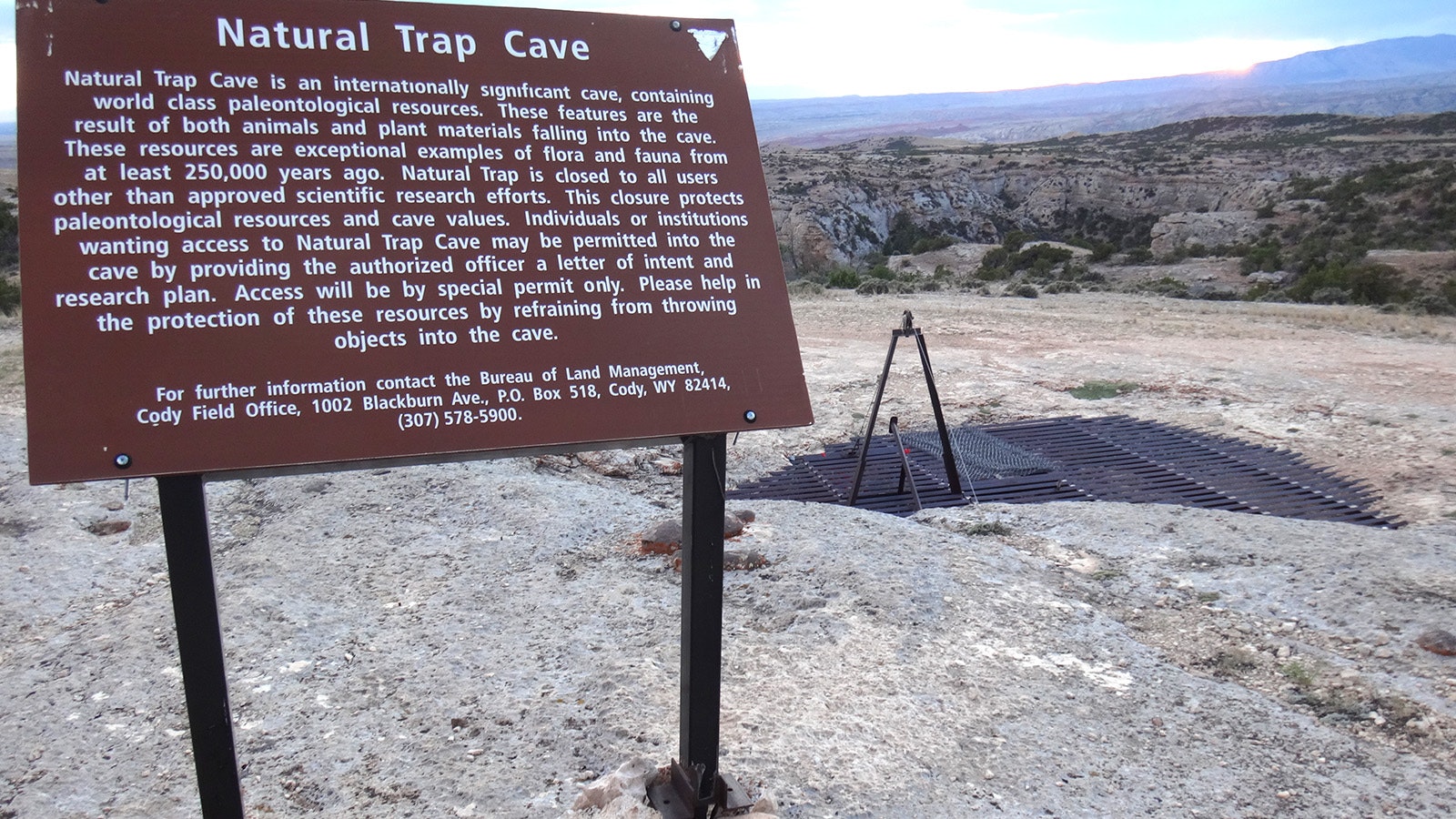 This sign tells the story of Natural Trap Cave, which is covered nearby to prevent people and animals from falling into it.