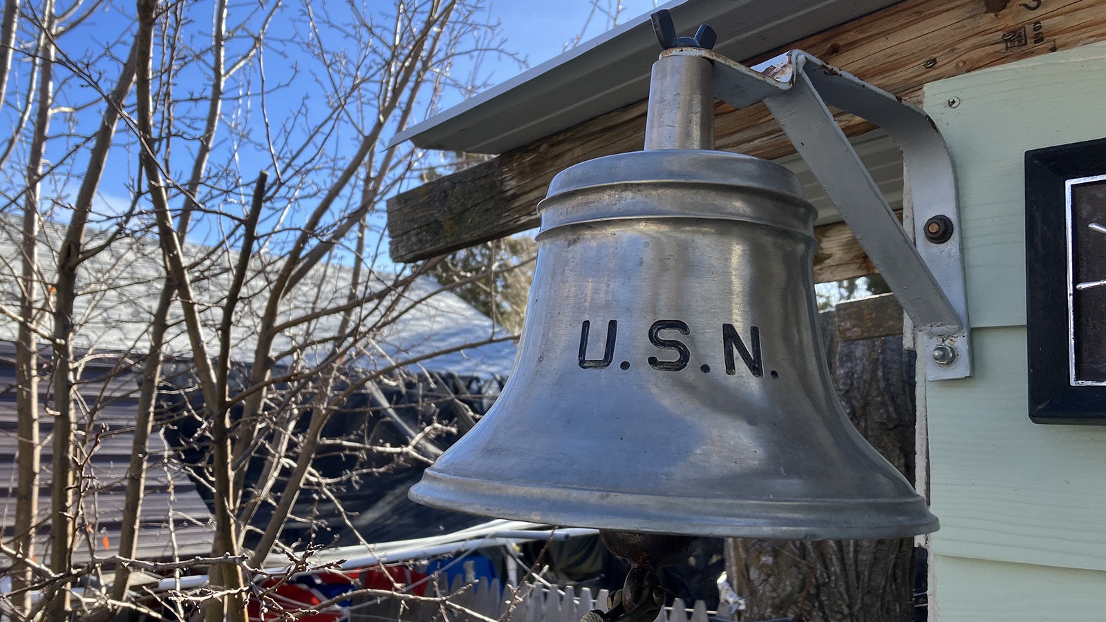 An original bell off the USS Currituck is mounted on the Dickersons’ porch to welcome visitors.