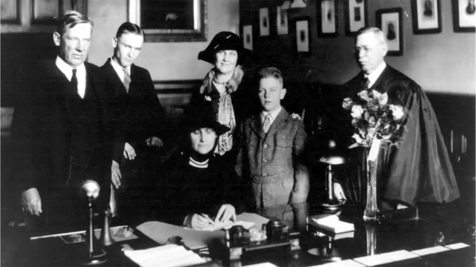 Nellie Tayloe Ross signing her oath of office as governor of Wyoming on Jan. 5, 1925. Behind her are, from left; Judge Samuel Tayloe, her brother; George Ross, her son; Mrs. Alfred Tayloe, her sister-in-law; William Bradford Ross, her youngest son; and Wyoming Supreme Court Chief Justice C.N. Potter, who administered the oath of office.